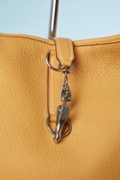 Gold grain leather "Trim II " bag with silver hardware Hermès