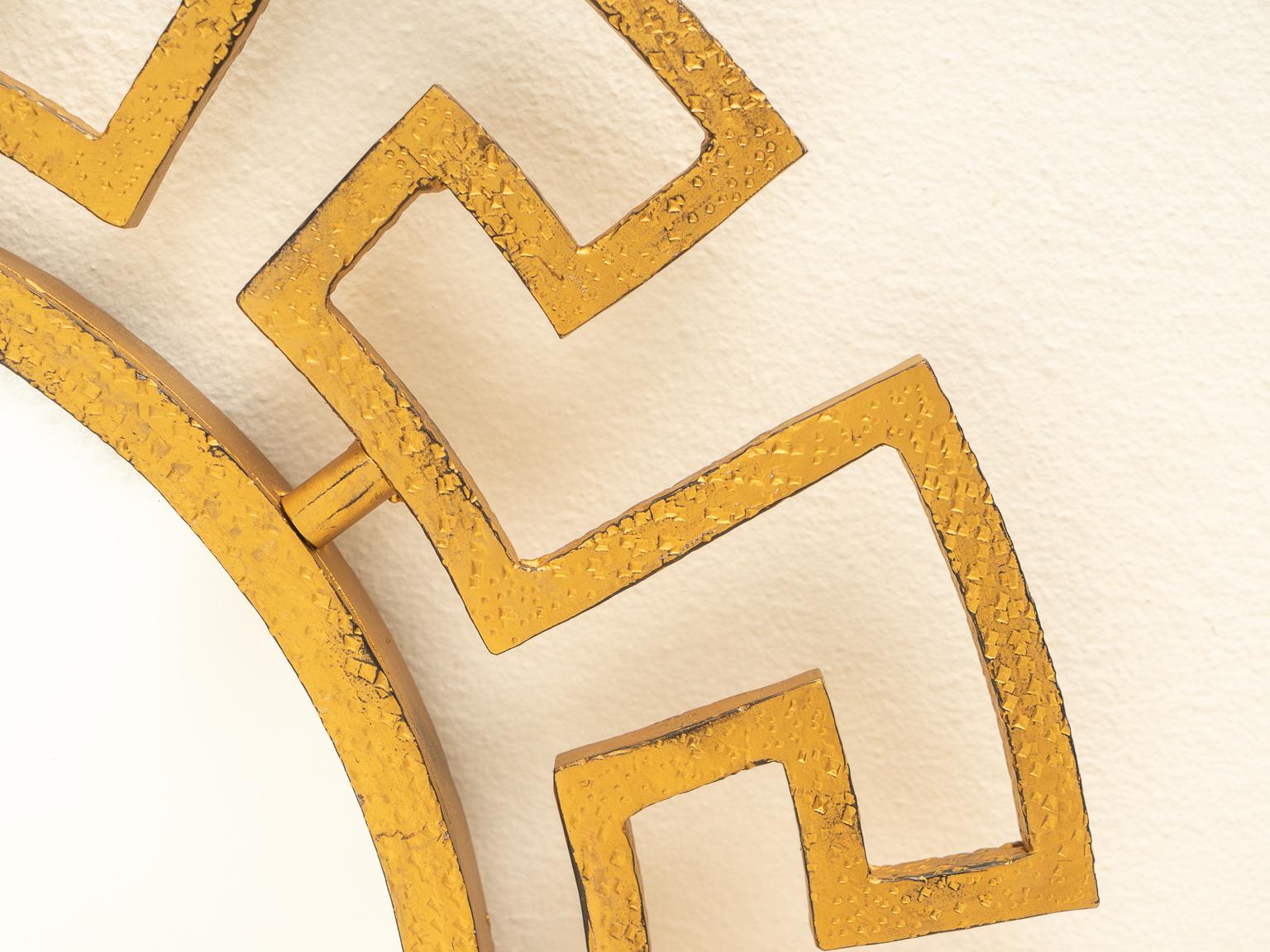 This stylish and chic wall mirror will add a bit of Hollywood Regency style to your home, and with its classic Greek key pattern it will remain timeless.

The piece is fabricate in wrought iron with a gold color finish.

Note: Dimension of mirror is