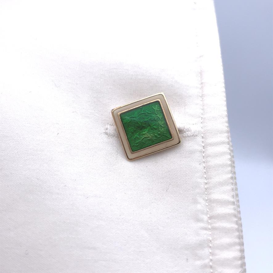 14K gold square double-sided cufflinks. Brillant green guilloche enamel center with cream enamel border.
Striking shape and color