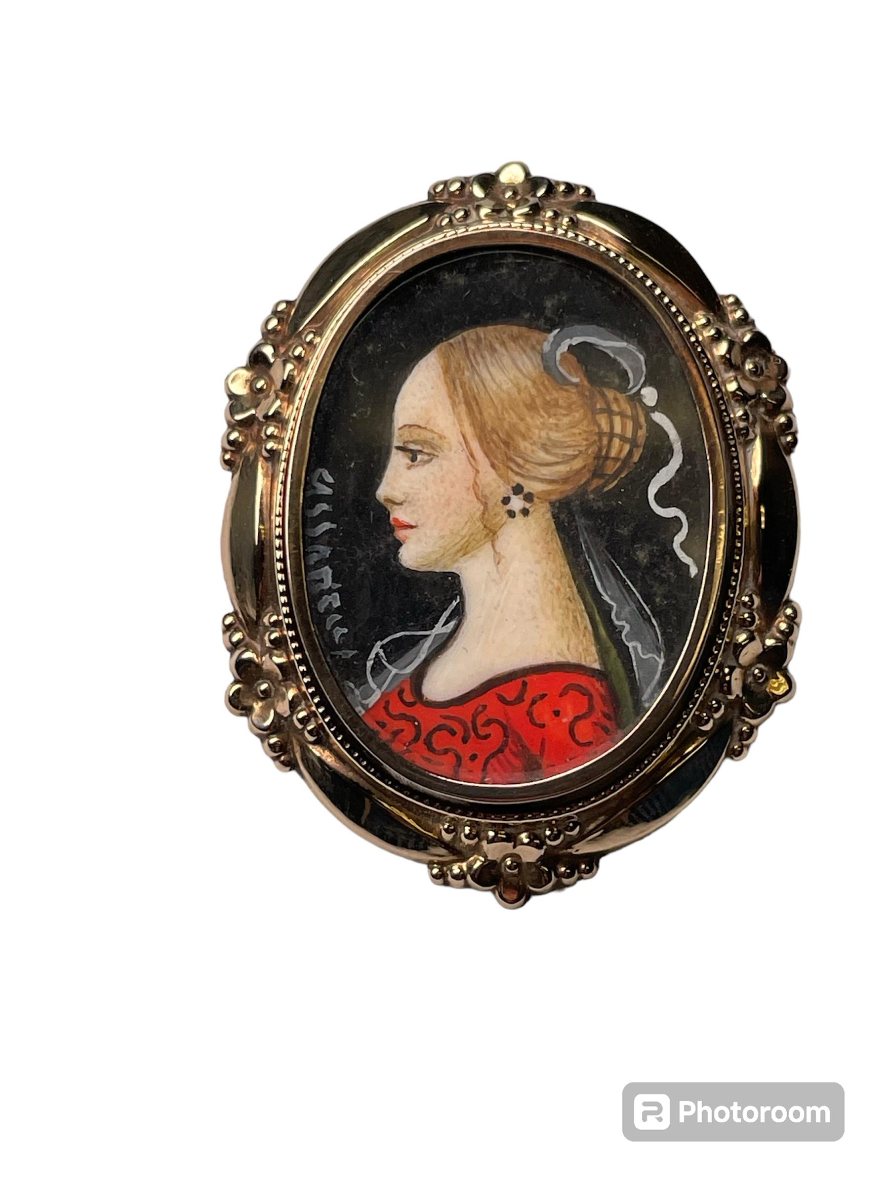 This is an Italian 18Kt yellow gold young lady portrait brooch. It depicts an oval shaped brooch with a hand painted miniature painting of an 18th century young lady wearing a hairnet over a chignon with small veil, pair of earrings and a red