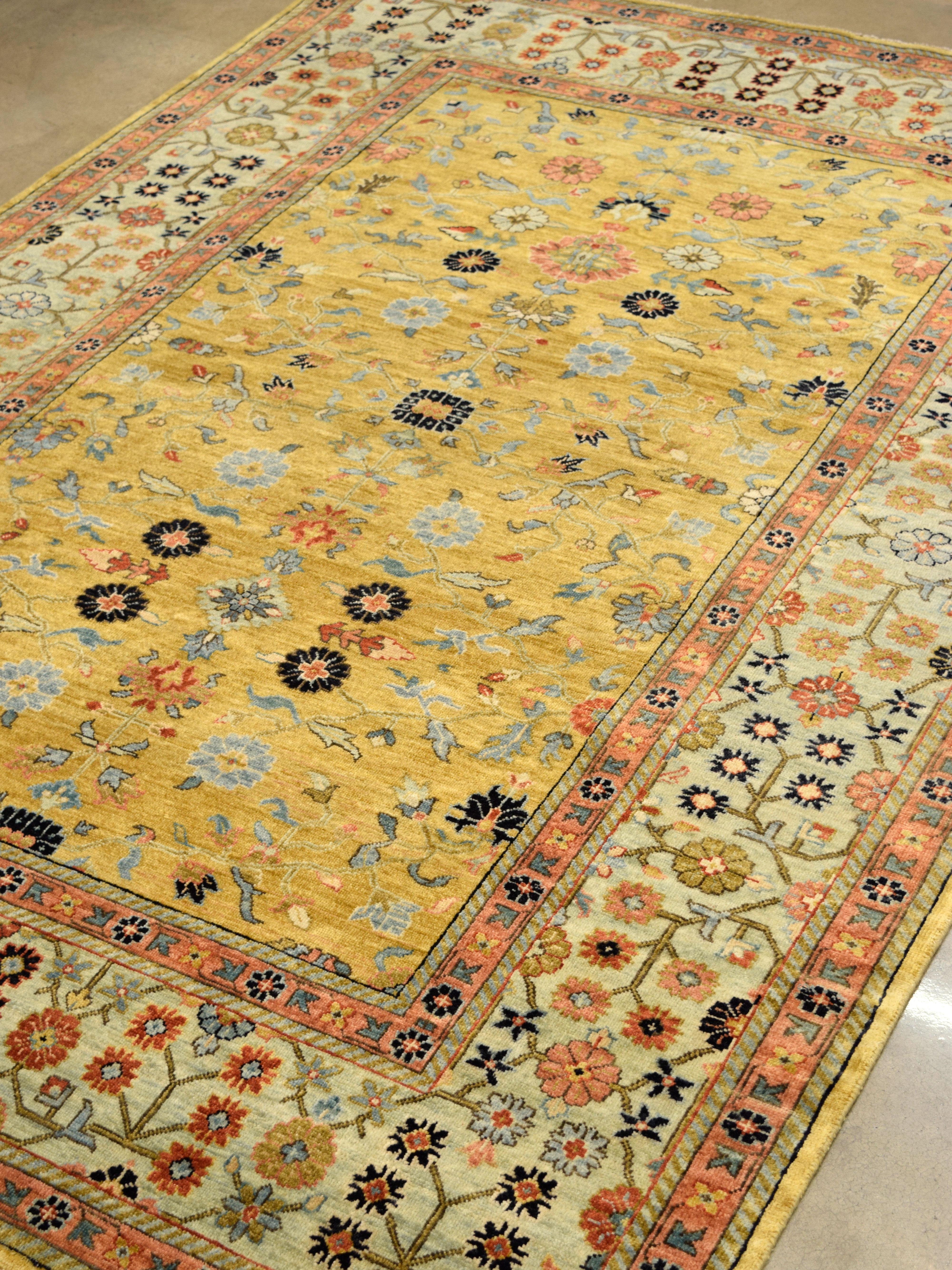 Indian Gold Handknotted Rug with Blue Border, Pink, Green, and Floral Motifs, 6' x 9' For Sale
