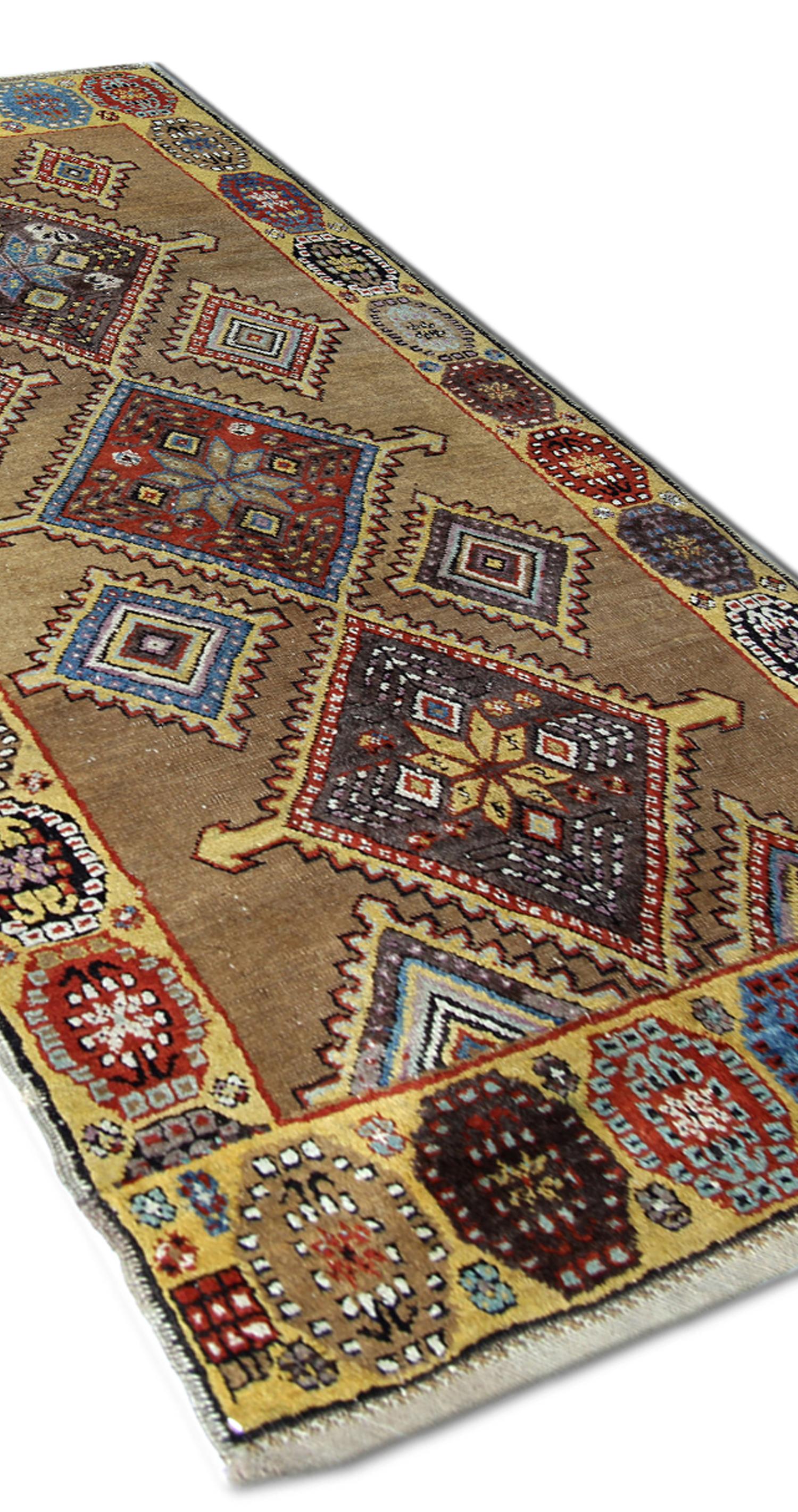 This fine wool area rug is an Antique are rug woven by hand circa 1880. This design features three large central medallions woven on a beige background in accents of blue red and brown. This is then framed by a highly-decorative repeating pattern