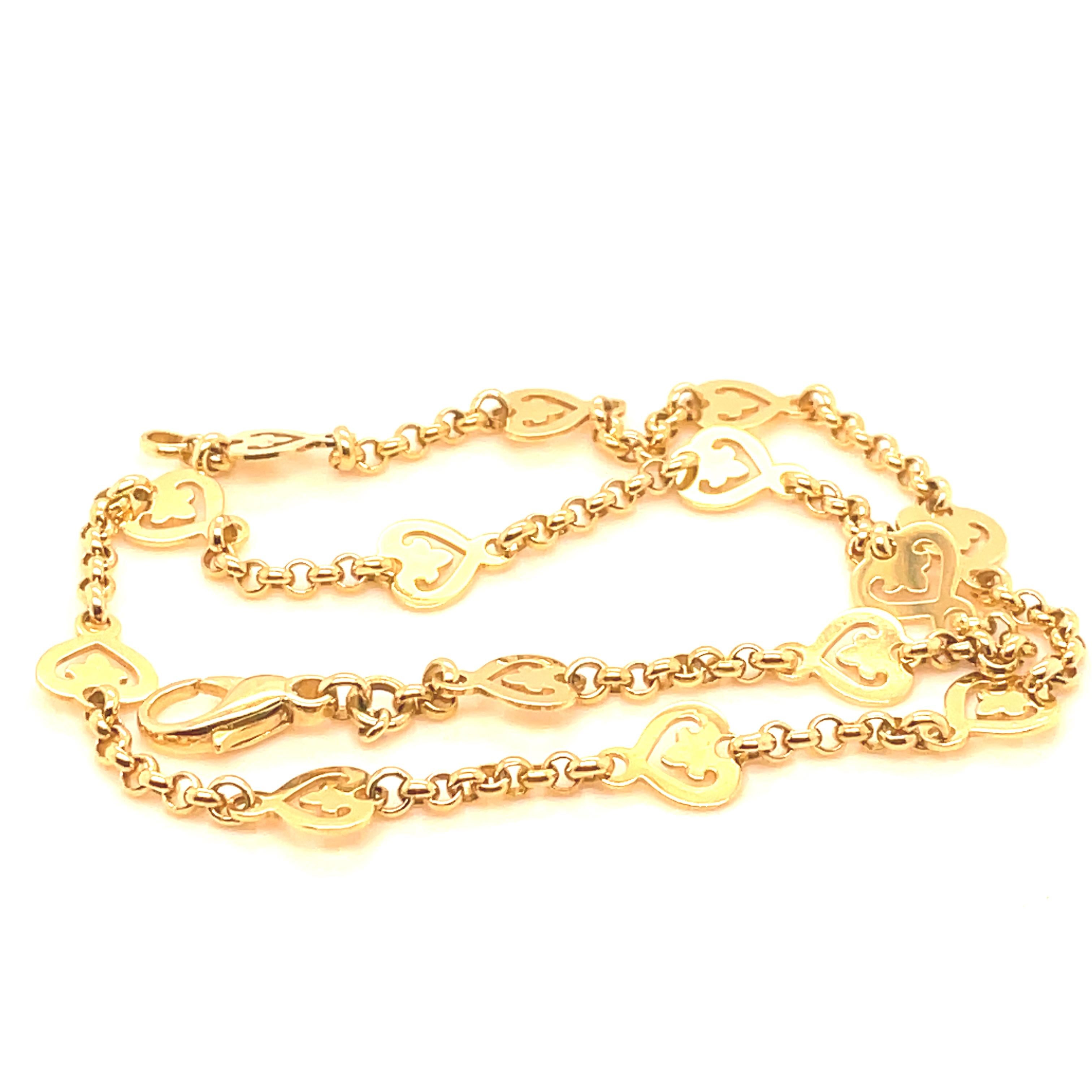 Lovely, lovely necklace:  open link chain set with fourteen open heart motifs.  18K yellow gold.  16
