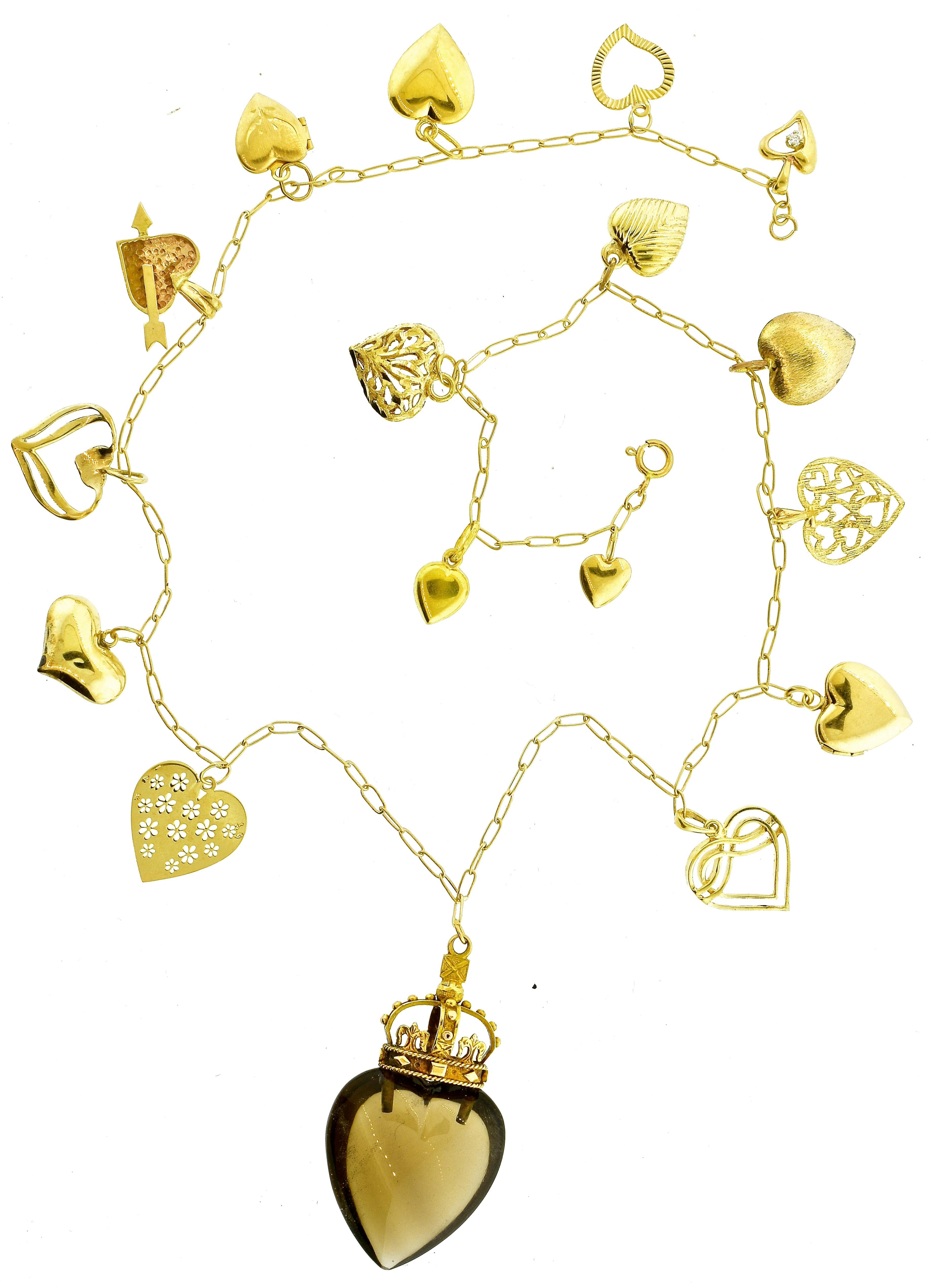 Heart motif necklace with 17 different heart motif charms. All yellow gold, one with a small white diamond, one is a locket and opens and the bottom center heart is a natural smokey quartz stone, all are unusual.  This necklace, in fine condition,