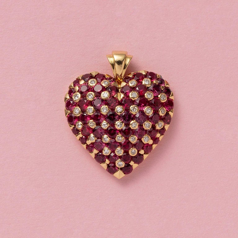 An 18-carat gold, heart-shaped pendant, pavé set with natural rubies – a few are heated – with brilliant-cut diamonds in between.

weight: 7.51 grams
dimension: 2.8 x 2.50 cm