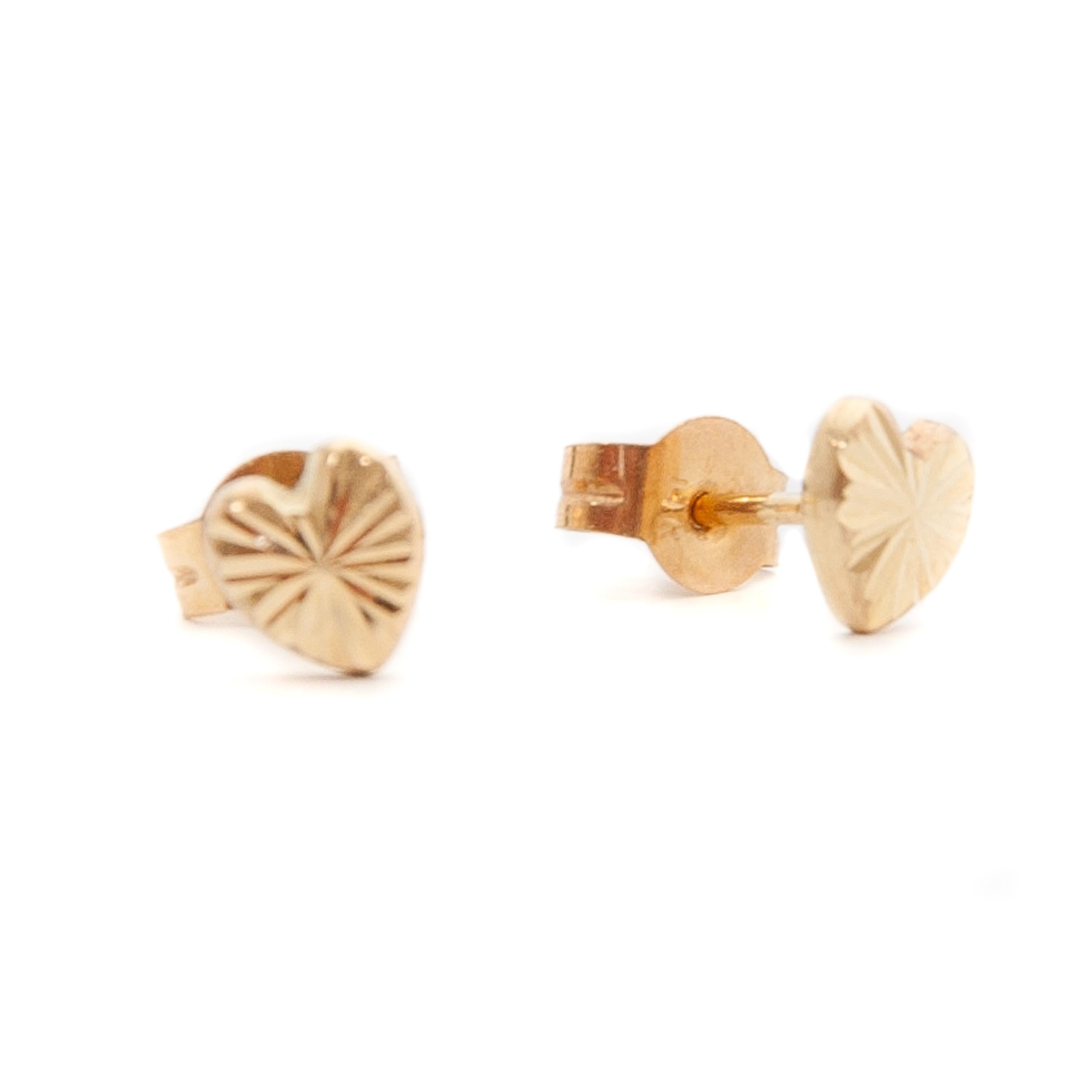 These lovely heart-shaped stud earring are made of 14 karat yellow gold. This timeless symbol of love is delicately detailed with a sunburst engraving. The earrings have a push back closure and are super wearable with any outfit. They also can be