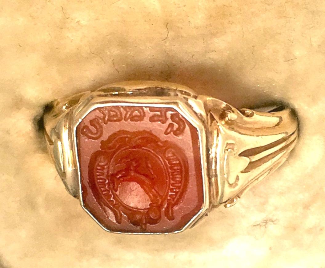 An early 19th century gold Carnelian Hebrew Intaglio Signet Ring in octagonal shape. The carnelian is inscribed with an image of what appears to be an antlered animal in motion, likely a stag or gazelle, a horseshoe, and four Hebrew letters which