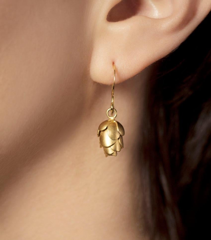 Pine Cones, a symbol of new life and beginnings is captured by these delicate hand made gems.
Each pine cone scale is hand cut from a sheet of gold and formed to make these delicate and light earrings as they capture the light. 

You will receive