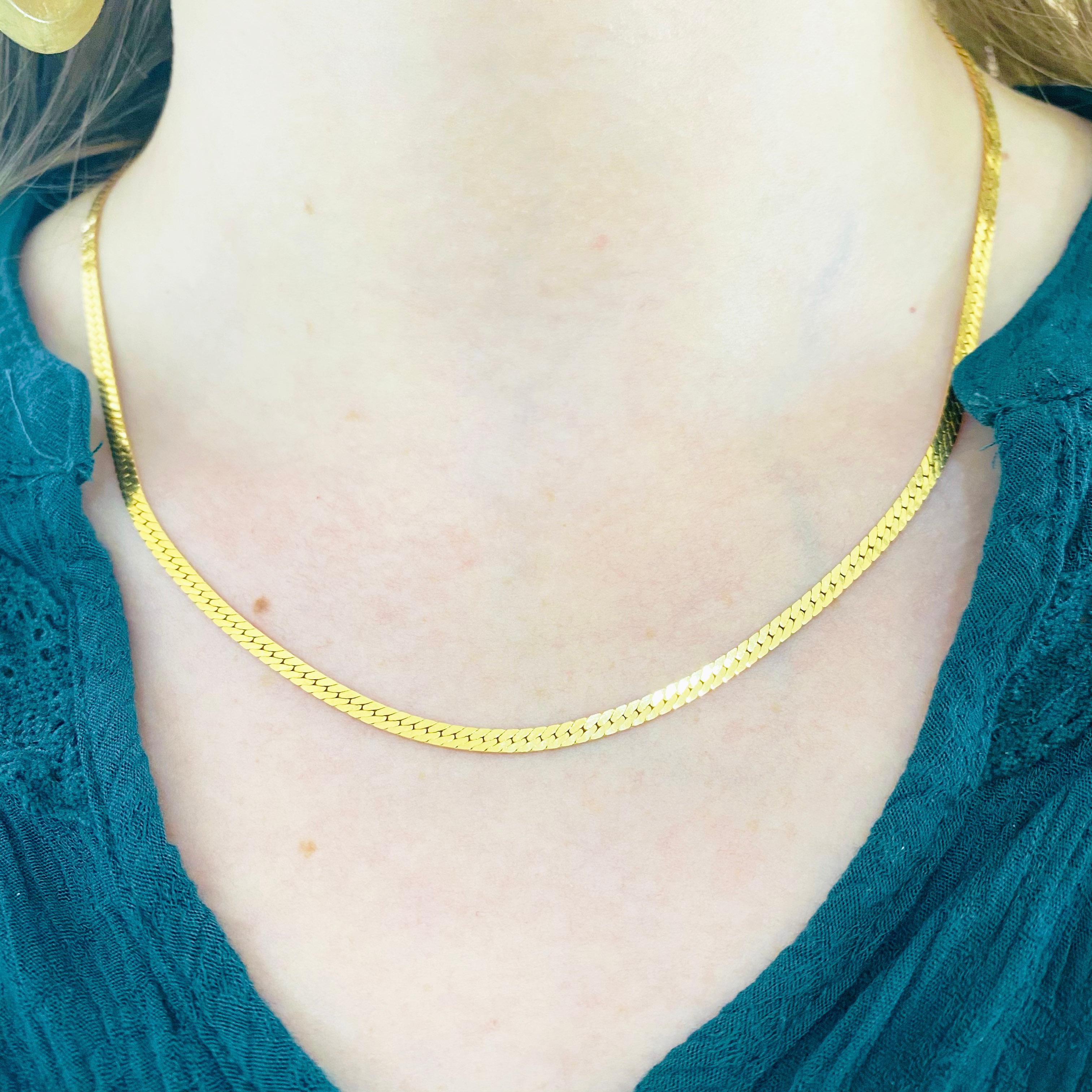 The 14 karat yellow gold herringbone chain, or flat gold chain style, which dates back to ancient Egyptian times, is a sophisticated design. It gets its name from the herringbone fish, a fish  known for their many parallel and slanted bones and this