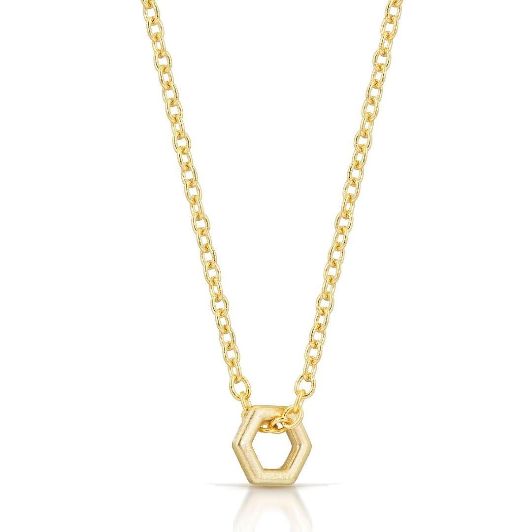 A small, dainty solid gold hexagon hangs from a simple curb chain. It really is too cute.

-18k solid gold
-16