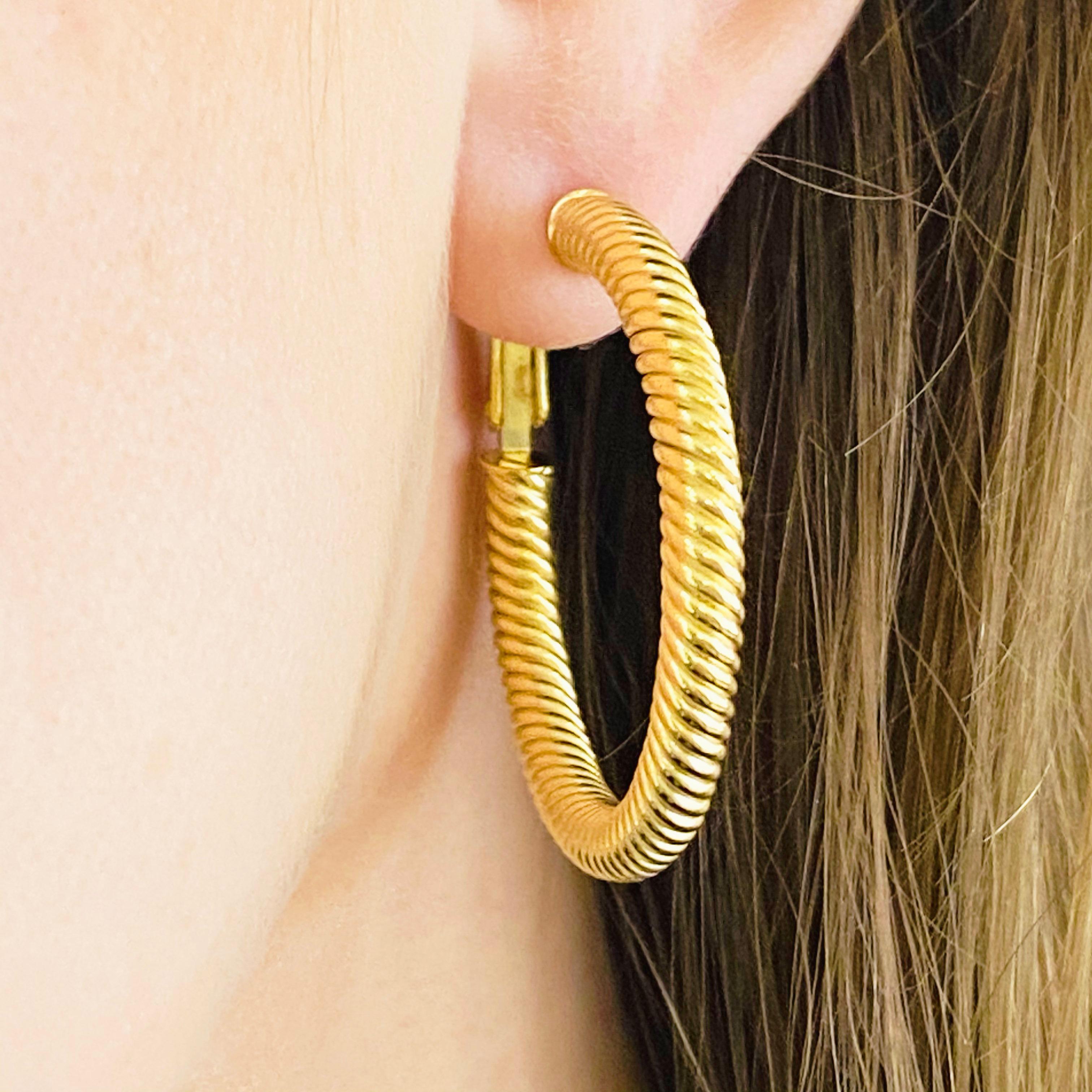 These stunning twisted 14k yellow gold hoops provide a look that is both trendy and classic. While they were once worn by kings and queens to signify power and social status, hoop earrings are now considered a statement of unity and strength. Hoop