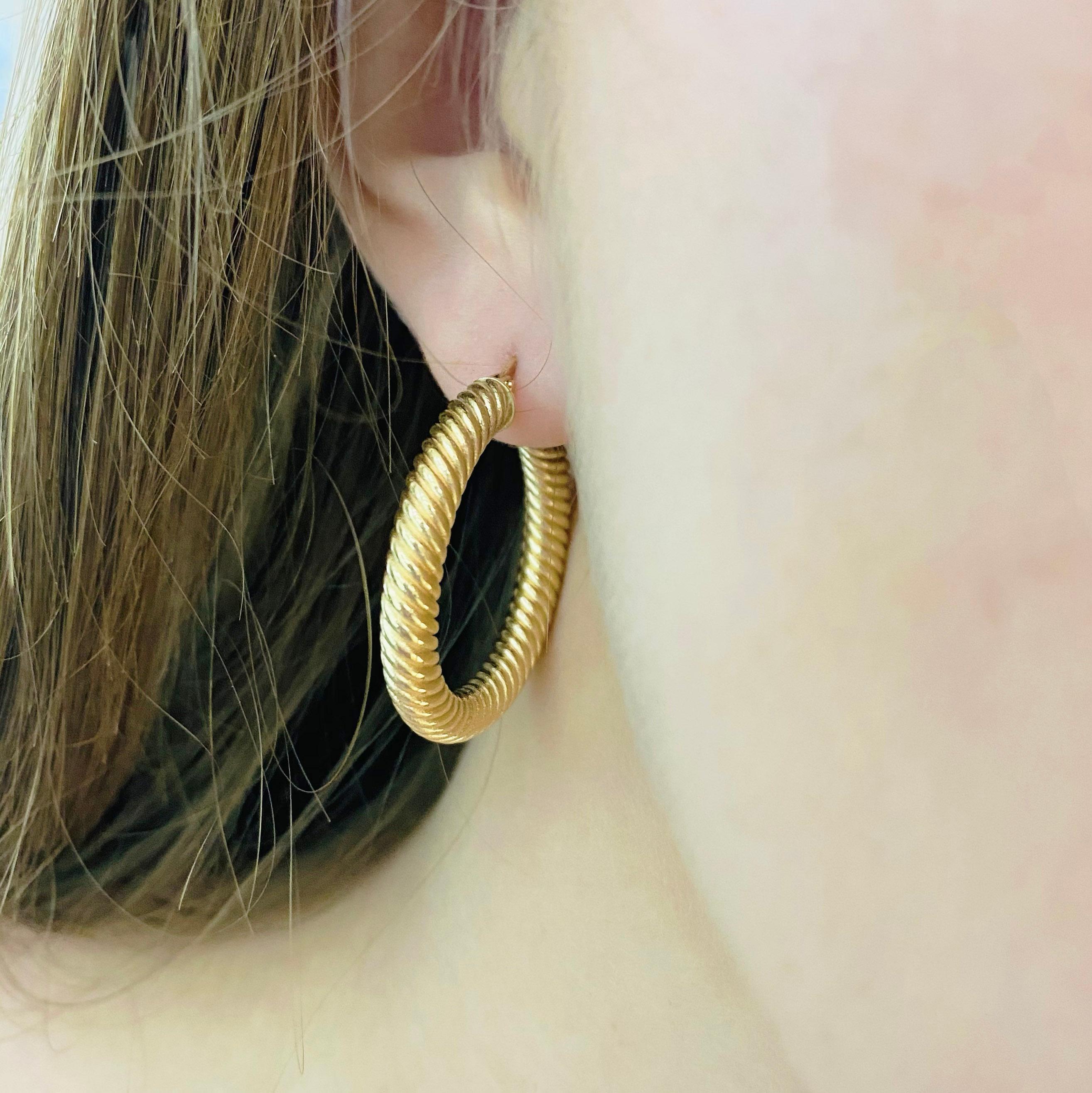 These stunning twisted 14k yellow gold hoops provide a look that is both trendy and classic. While they were once worn by kings and queens to signify power and social status, hoop earrings are now considered a statement of unity and strength. Hoop