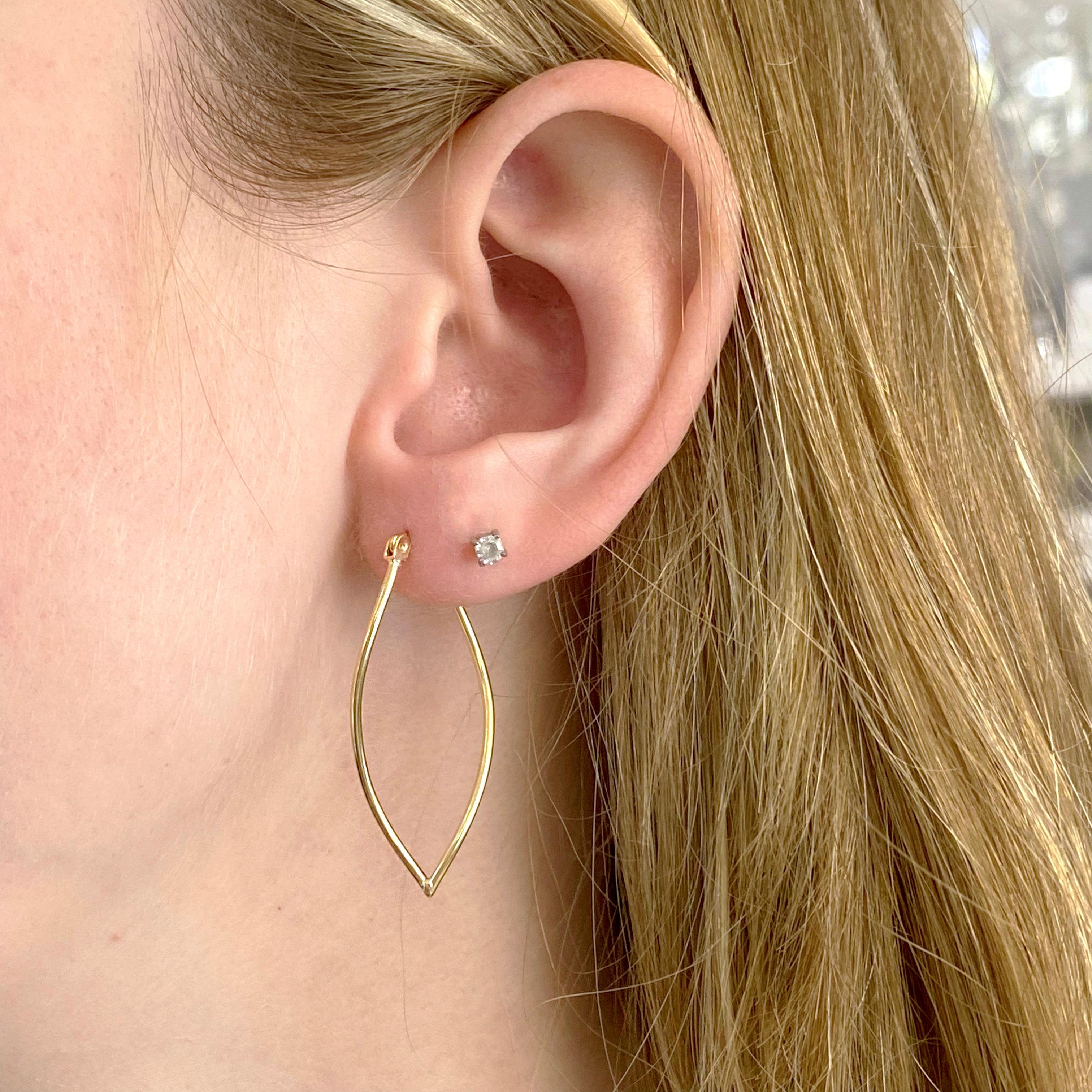 14k Gold Hoop Earrings with a twist. The earrings are a pointed hoop that look amazing on any neck. They are lightweight so that they do not pull on your earlobe and are so unique! You will love these earrings! They have a 14 karat yellow gold