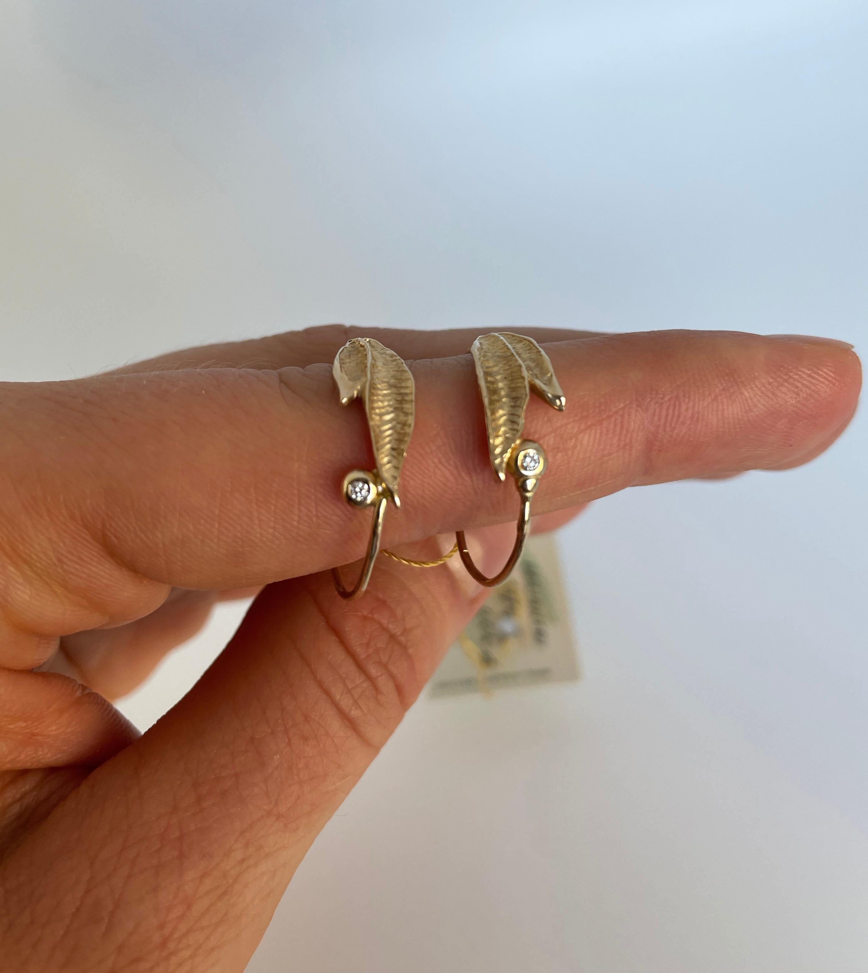 Beautiful 14 - carat yellow gold hoop earrings with diamonds.

Here, the gold obeys the creator's magic hands and shines in a stunning, leaf-like pattern, further enriched by the sparkling diamond stone.

Due to exceptional craftsmanship, these