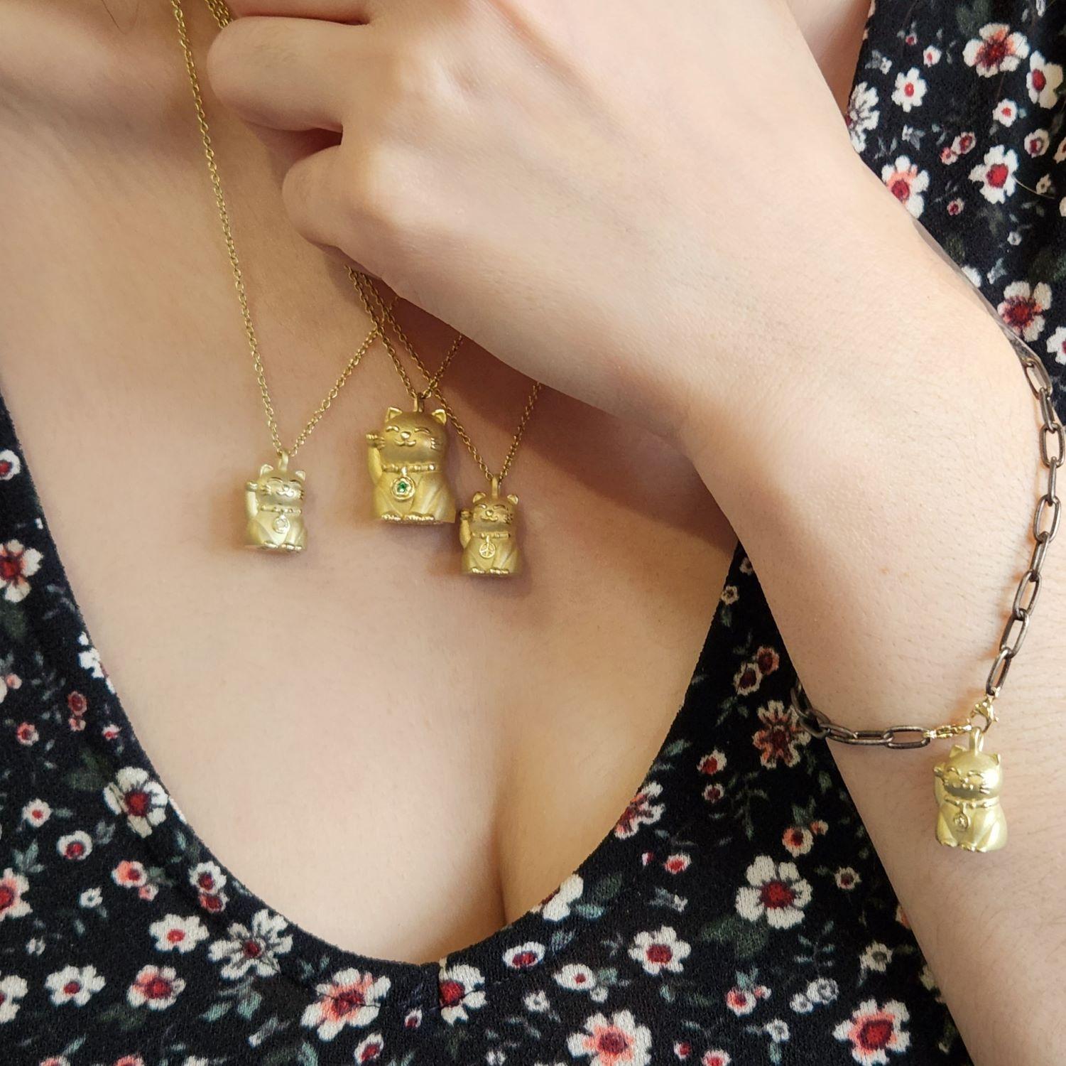 Inspired by the Japanese Maneki Neko welcoming Cat, Alison has reimagined this beloved symbol of a charming, happy, lucky, and inviting/beckoning cat in a variety of sizes, gemstones, and metals.
Alison challenged herself and succeeded to make The