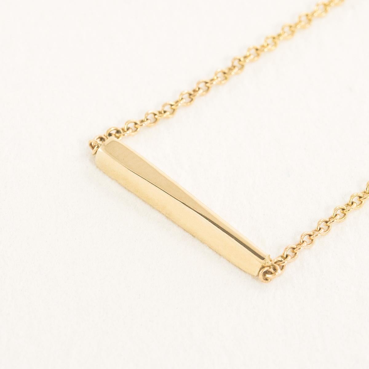 The Interval Bar Necklace shifts from square to triangle end to end. Dynamic and easy, this necklace is a study in subtle motion. A delicate but sturdy 16”/ 1 mm Italian chain makes this piece durable for everyday wear. Crafted in solid 14k gold,