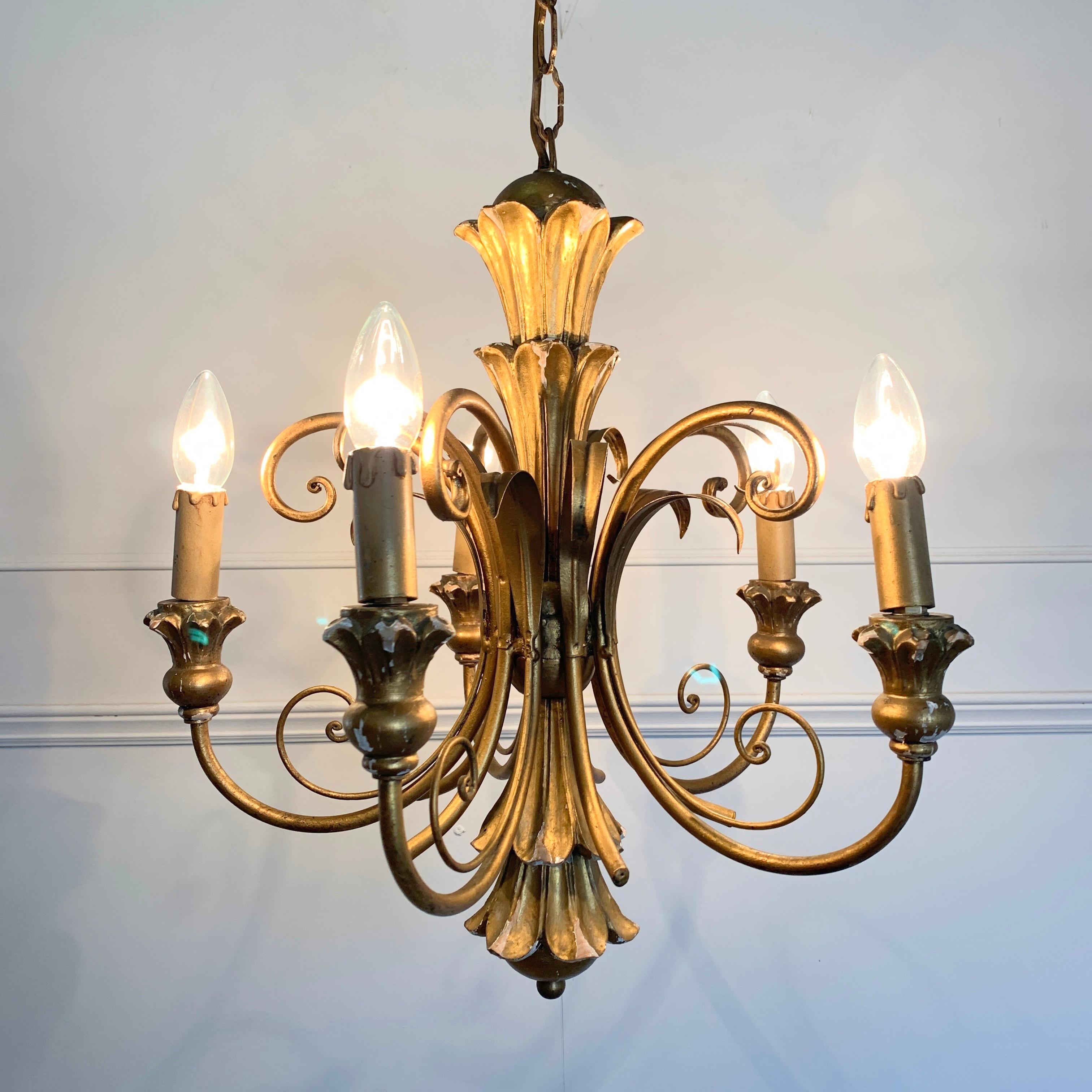 Italian giltwood scroll chandelier, circa 1960s
The carved wooden central finial is decorated with its gesso and gilt finish
Scroll wirework tendrils and metal arms reach out to the wooden lamp holders
There are 5 bulb holders, E14 small screw in