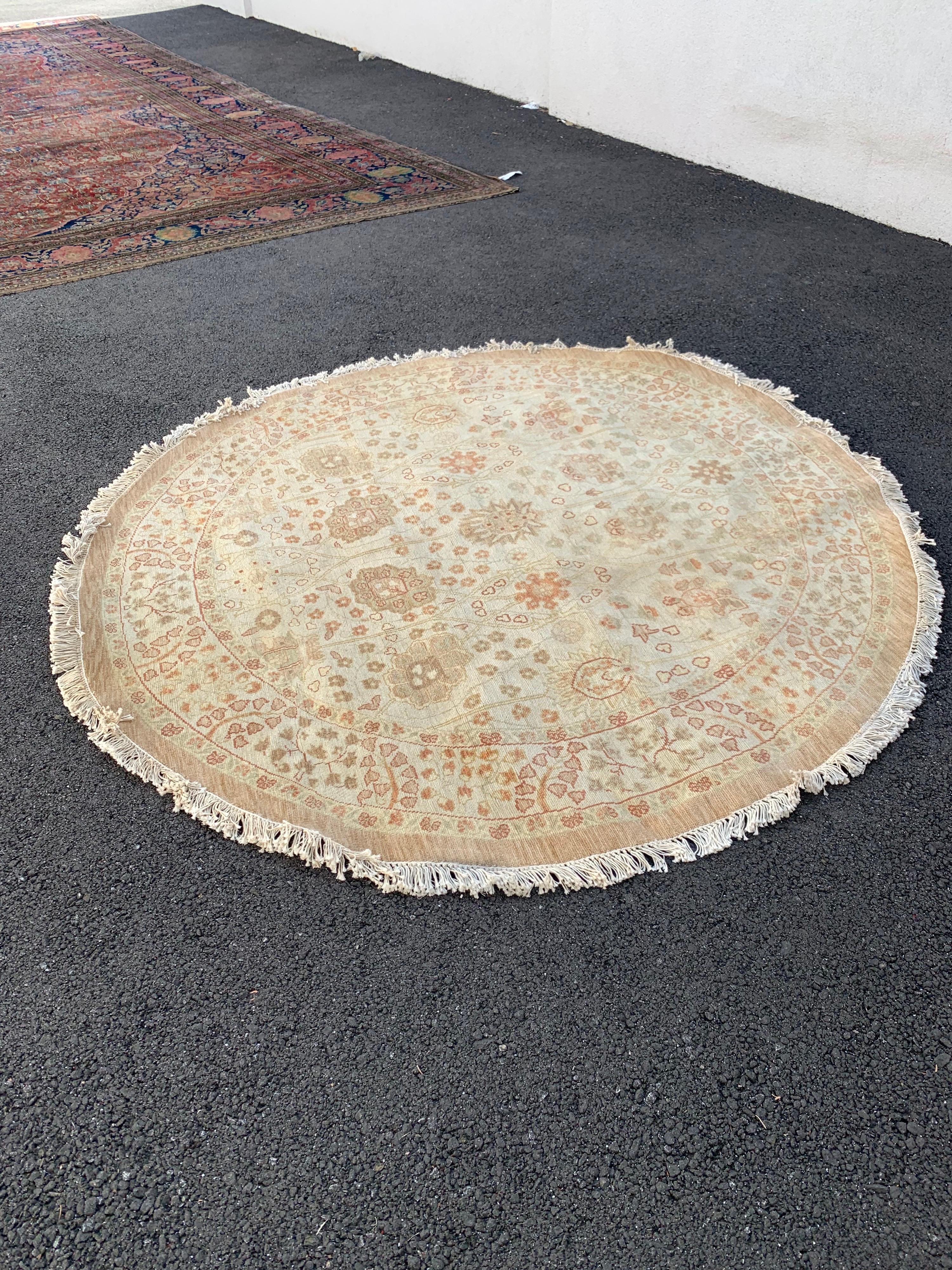 This is a new rug in Persian design handwoven in Alexandria, Egypt in the 1990s. We manufactured these rugs and the design and colors were hand chosen by us and we have a wide variety of sizes in this style. This one measures 5.2 ft in diameter with