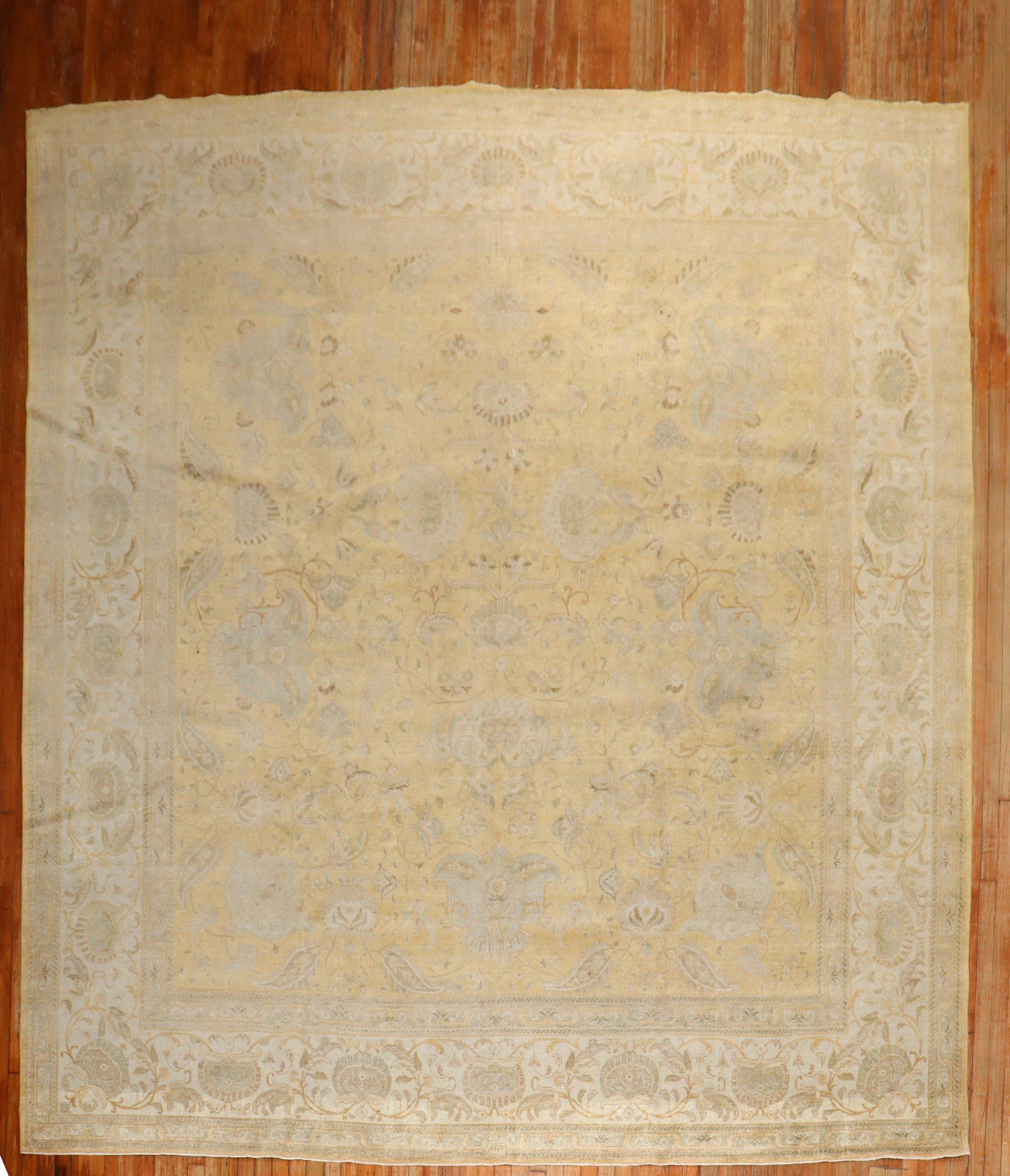 An early 20th-century antique Persian Tabriz room-size square rug in gold and ivory tones

Measure: 10'8'' x 12'5''

Tabriz rug weavers drew on a varied repertoire of delicate designs: multi-faceted flowerheads, subtle arabesques, lush vinery