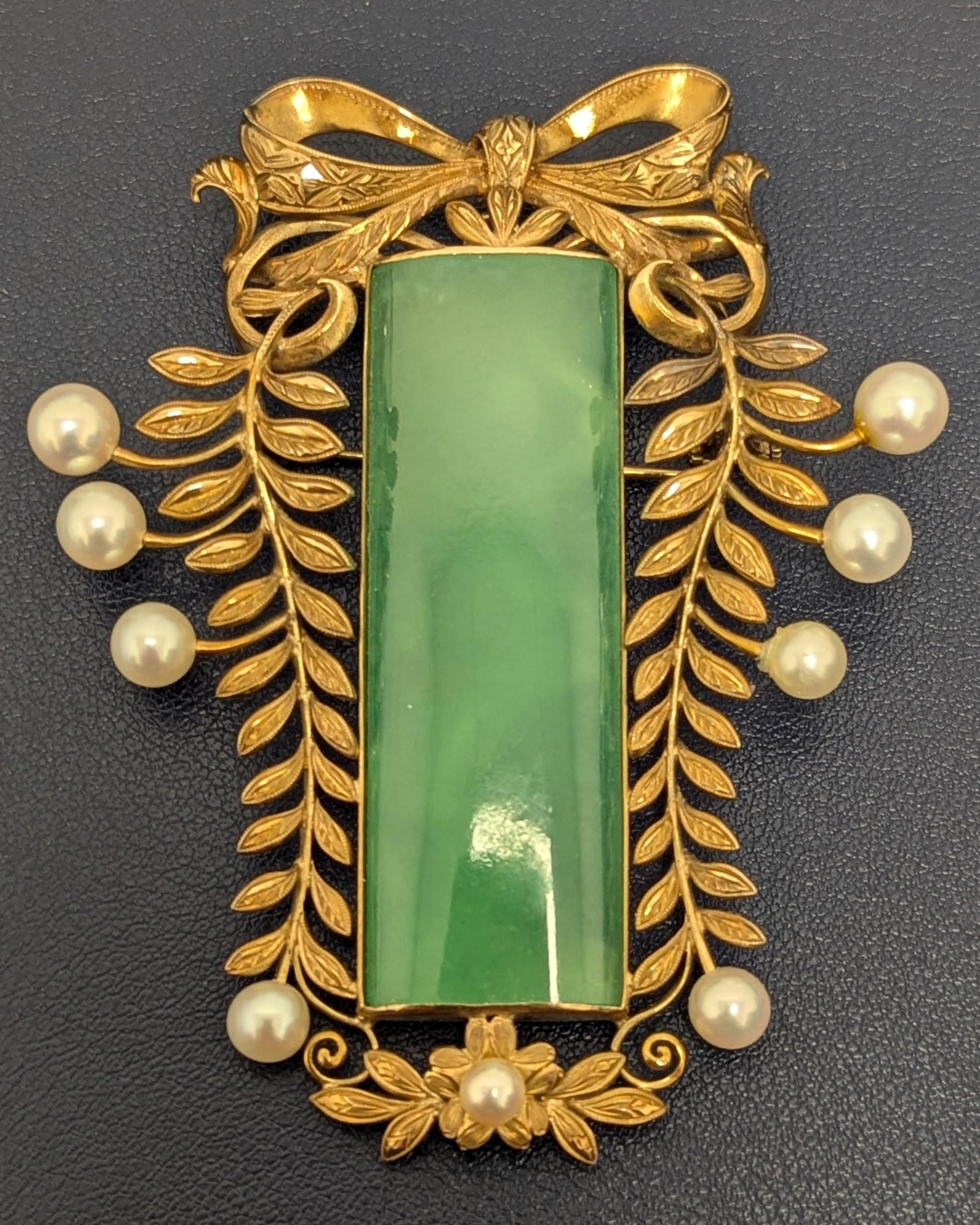 A treasure box necessity, this piece can be own as a pendant or brooch. It features a medium light green jade that is translucent and well polished and is surrounded in gold and creamy, cultured white pearls.