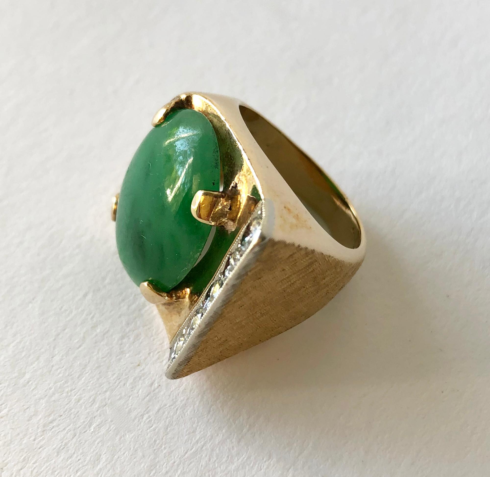 14K gold, jade and diamond heavy pinky ring, circa 1960's.  Ring is a finger size 6 and features a large jade cabochon and five diamonds at the rings flared edge.  It also has a Florentine finish on two sides.  It is signed 14K, with a partially