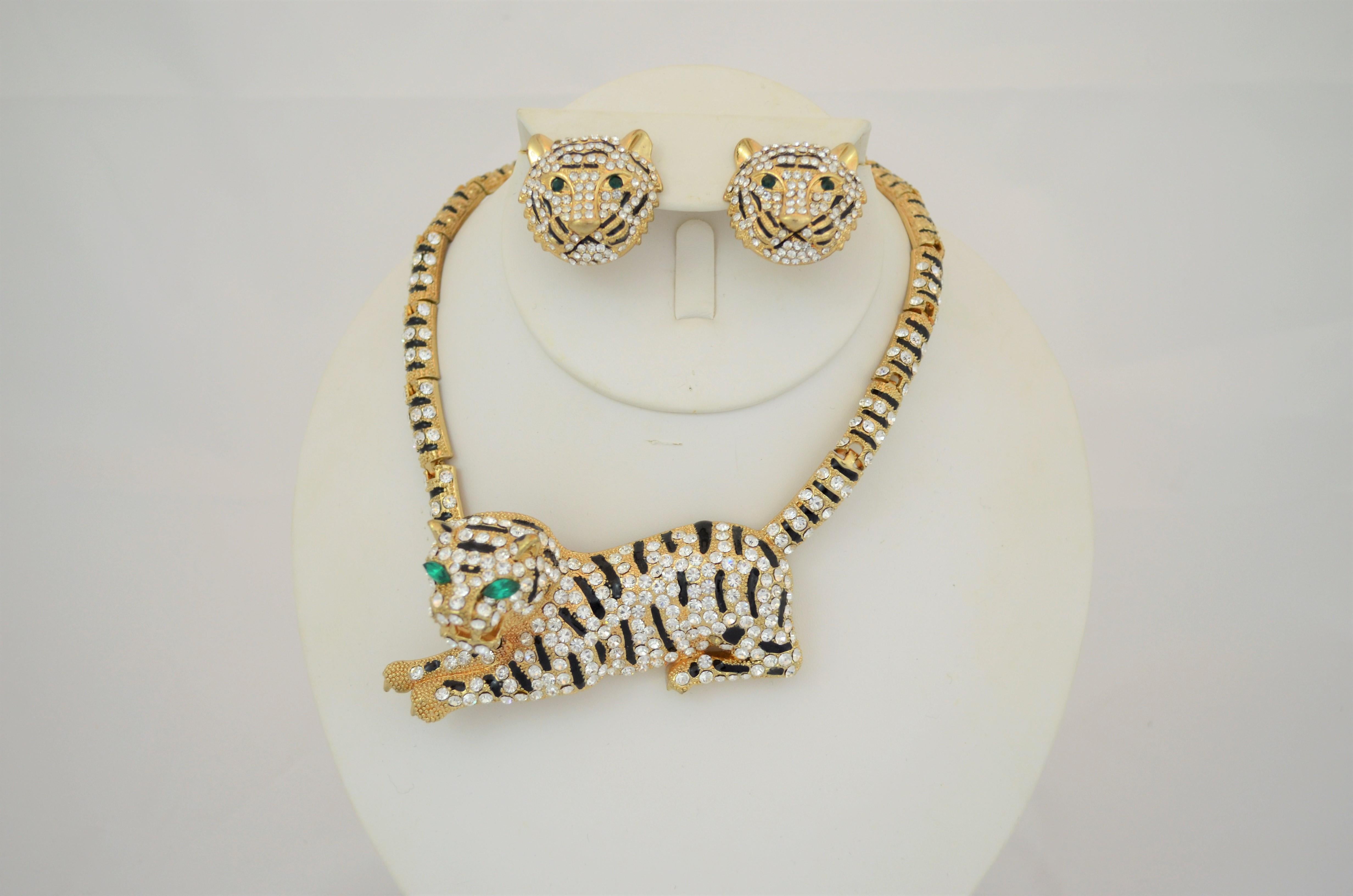 Gold Jaguar Necklace and Earrings Set with Rhinestones -- Featured in a gold-tone metal that is encrusted with rhinestones. Necklace measures 7 inches on each side with a snap clasp and the length of the jaguar measures 4 inches.