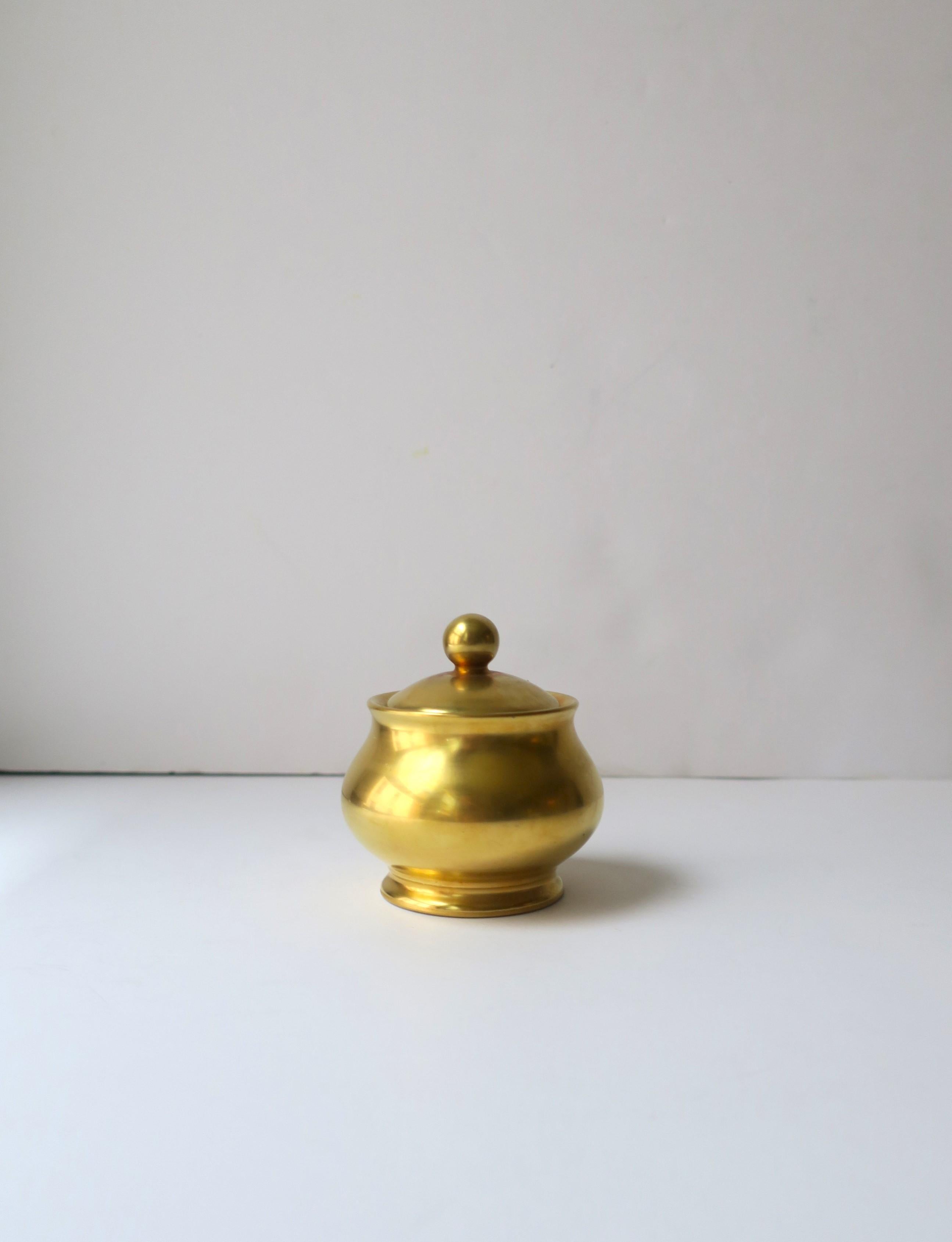 A beautiful gold Japanese porcelain condiments or sugar bowl and lid, circa early-21st century, Japan. Japan is known for its fine porcelain. Piece was made exclusively for Takashimaya Fifth Avenue, New York. Piece is covered in a rich gold satin