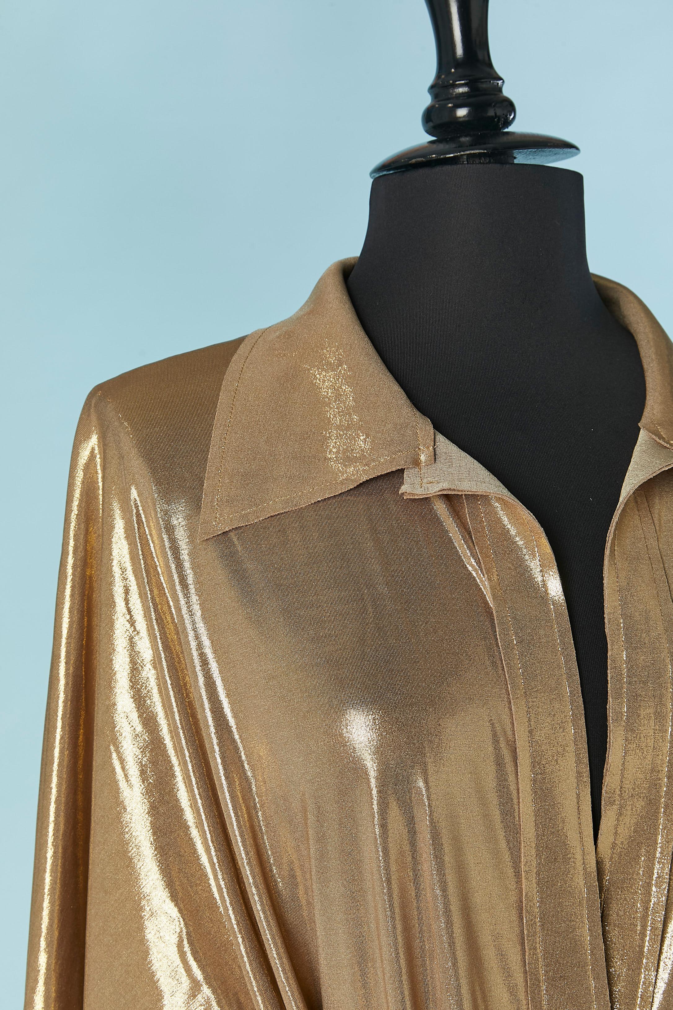 Gold jersey cocktail dress. 
Fabric composition: 95% polyester, 5% spandex 
Hoop&loop closure on the middle front.Raw cut edge . 
Tied on the middle front.
SIZE L 
