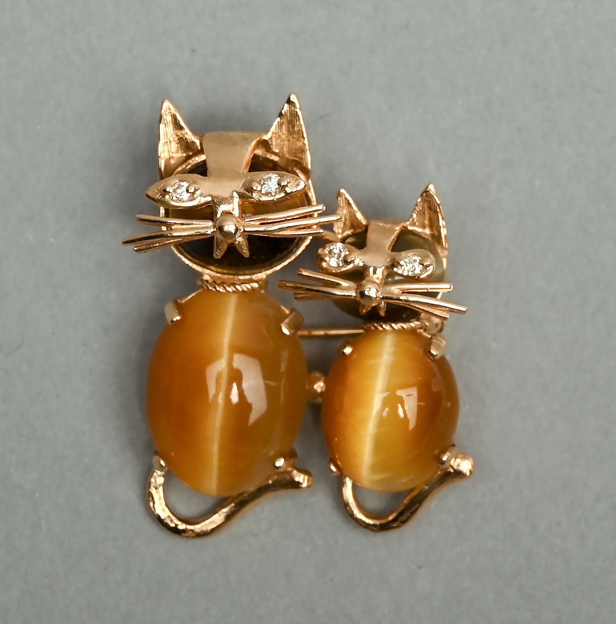 Two adorable kitties can be worn as either a brooch or a pendant. In addition to the pin stem, the back has a small loop from which one can attach a chain. The larger cat measures 1 1/4 