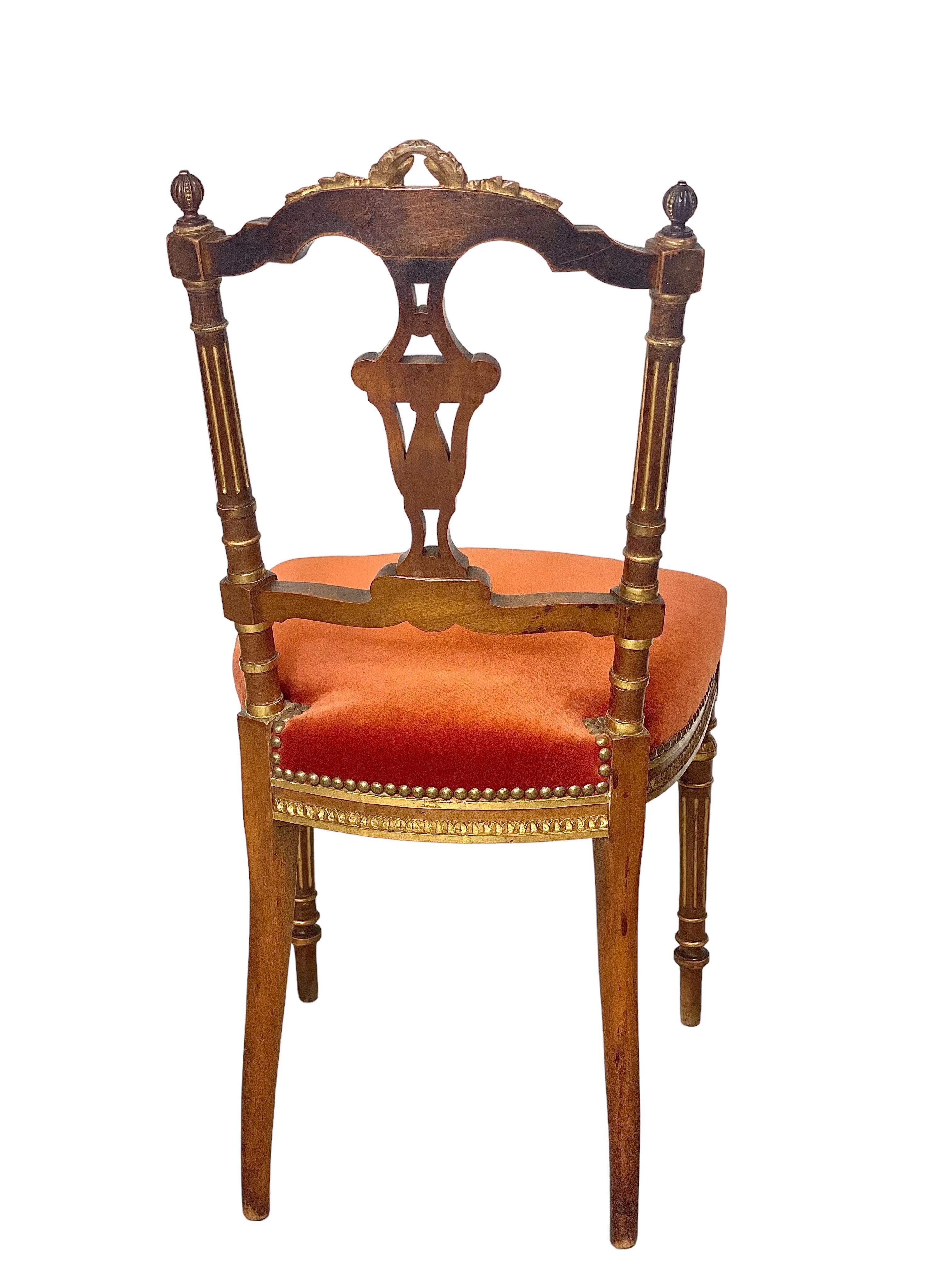 An elaborate and very attractive Napoleon III period cabaret, or lounge, chair, in sculpted and gold-lacquered wood. Slightly reclining in angle, the backrest is highly ornate, with a stylised vase design suspended at its centre. The top rail is