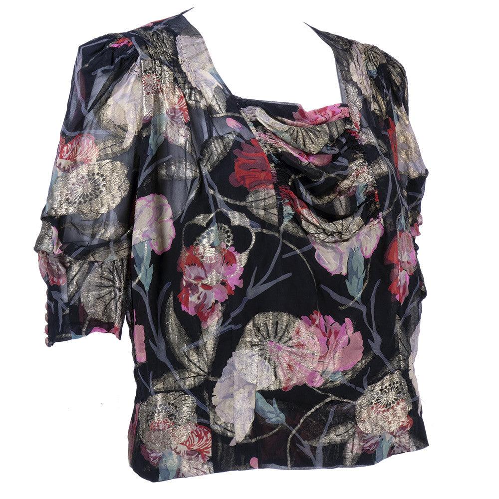 Gorgeous and dramatic 1930s lame floral blouse with squared neckline and semi-banded waist. Shirring and drape details. Slightly full sleeves. Excellent condition.
 
Additional information: 
Bust:  40