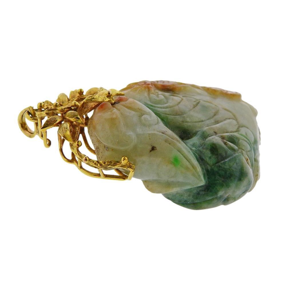 Large 14k gold pendant with carved jade. Pendant is 70mm x 44mm . Jade measures approx. 52mm x 44mm x 6.2mm. Marked HK 585. Weight 61.8 grams.