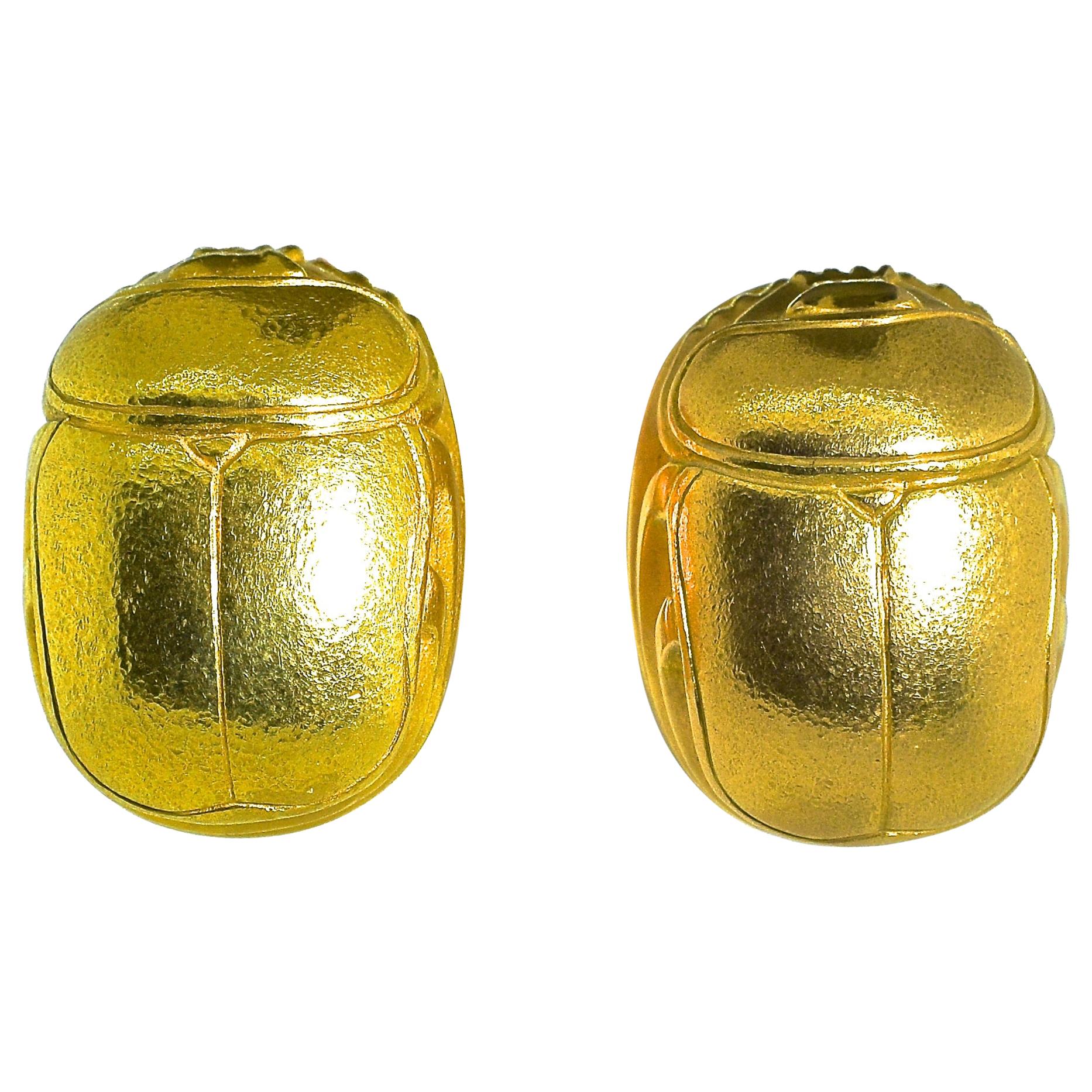 18K yellow gold earrings - robust and unusual - they cover the ear lobe with 1 inch by 3/4 inch of bright 18K yellow gold drafted in the classic image of a scarab - long life.  So referred by the ancient Egyptians that the Pharaoh's  final resting