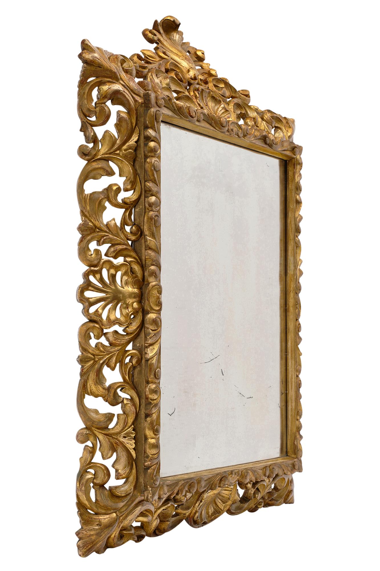 Gold leaf antique French mirror completely hand carved in the Baroque style with stylized acanthus and oak leaves. It has the original 23-carat gold leafing throughout, as well as the original mercury mirror. It is in excellent antique condition and