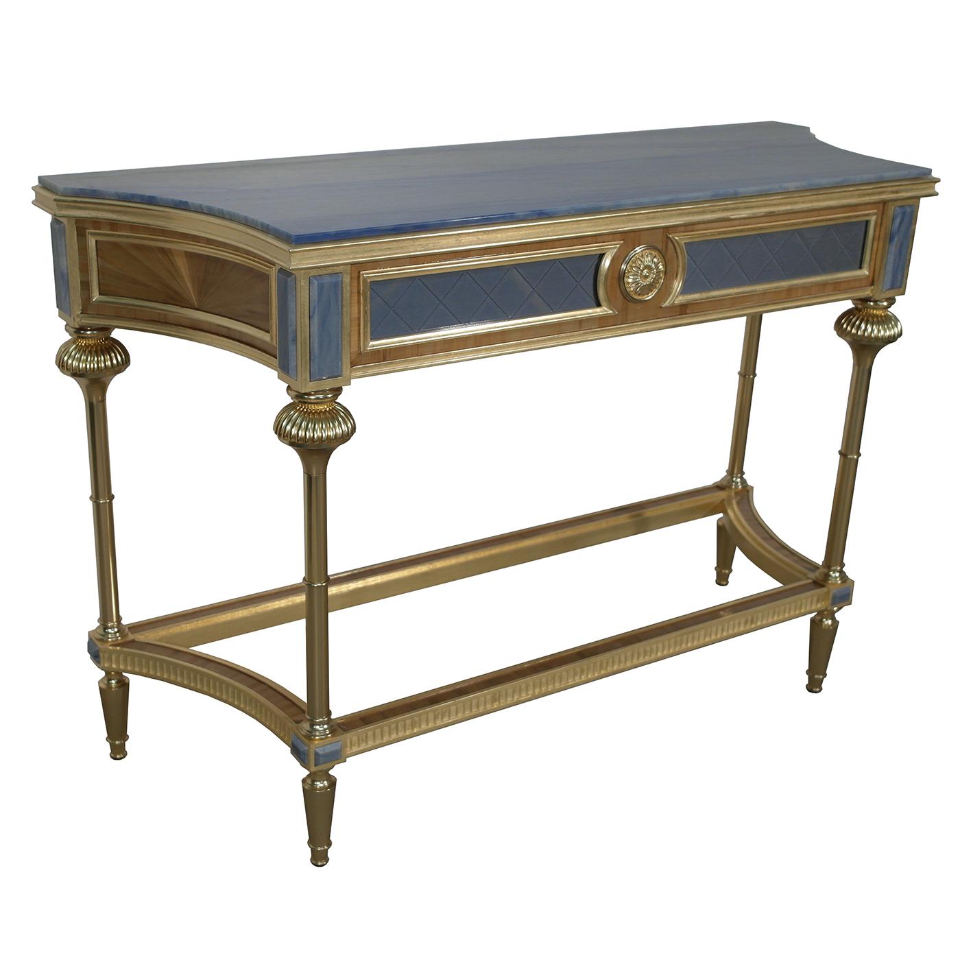 This opulent wooden console table combines natural straw veneer details with 22-karat gold-plated brass accents. The 22-karat gold leaf details boast a white patina treatment for a vintage look. The front is upholstered in blue silk, topped with