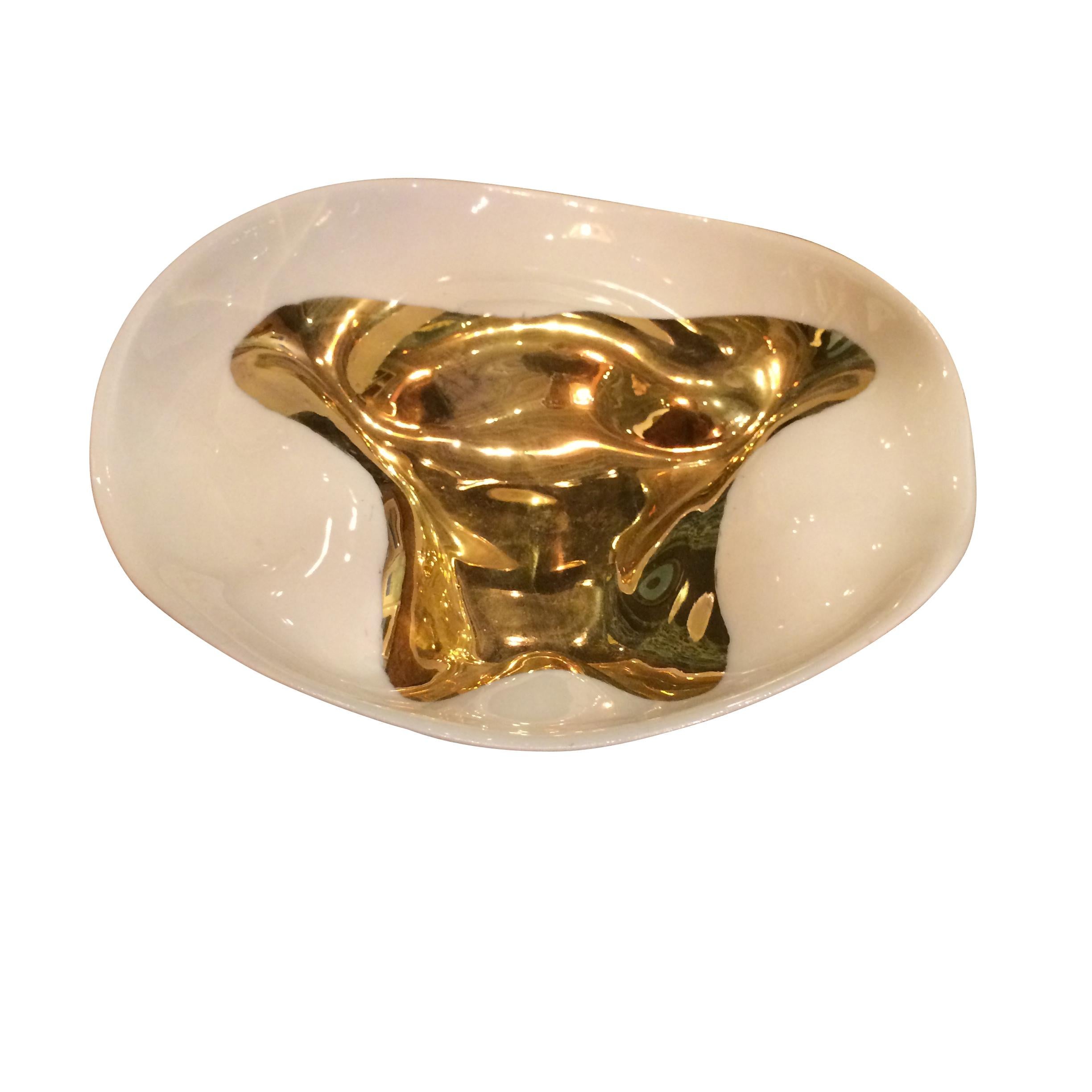 Handmade gold leaf accented bowl.
Free-form organic shape.
Fine ceramic base.
Similar bowls are available in 10