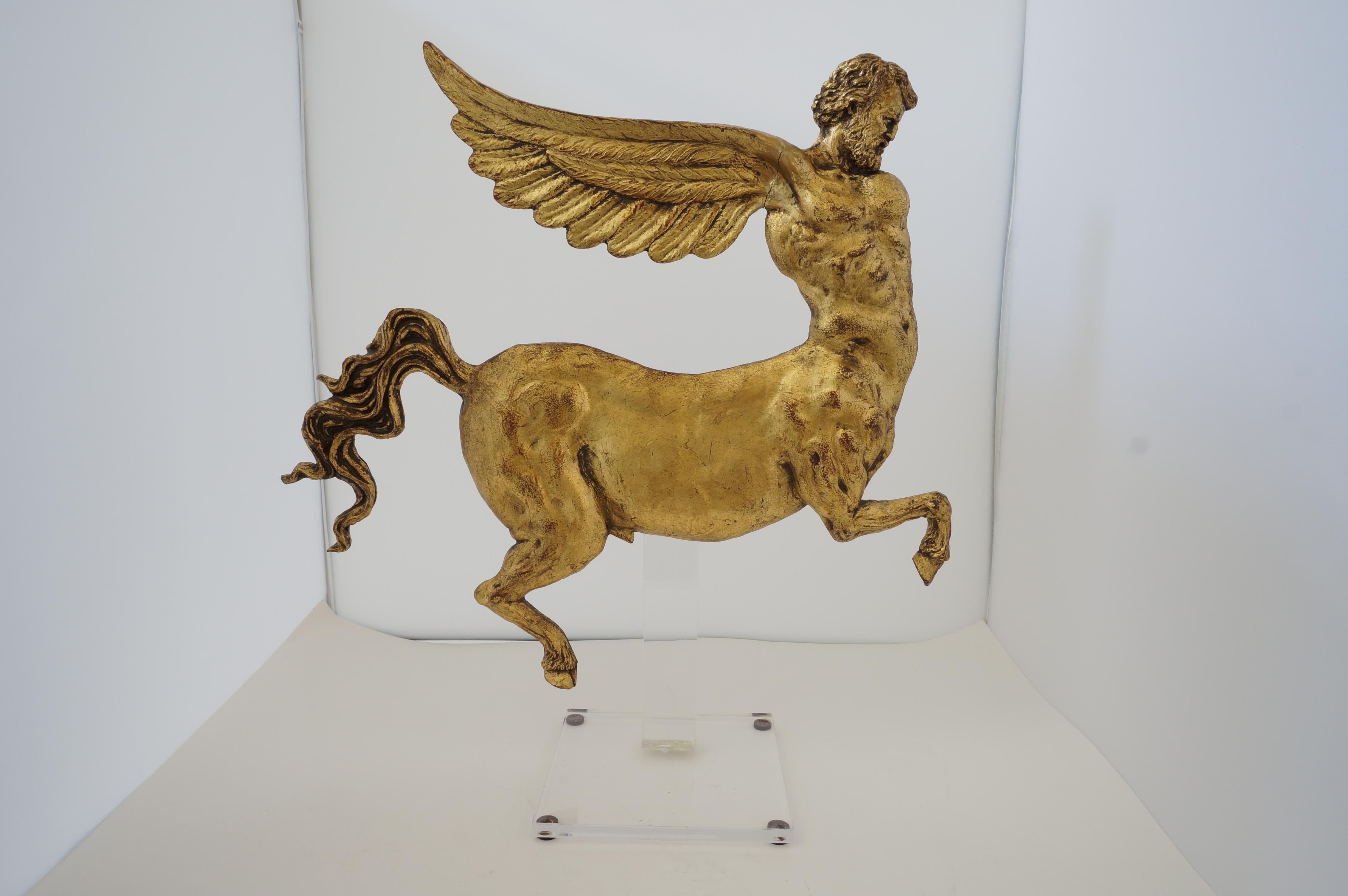 Antique Neoclassic Revival winged AlaCentaur figure with gold leaf from a Palm Beach estate. Custom Lucite stand.