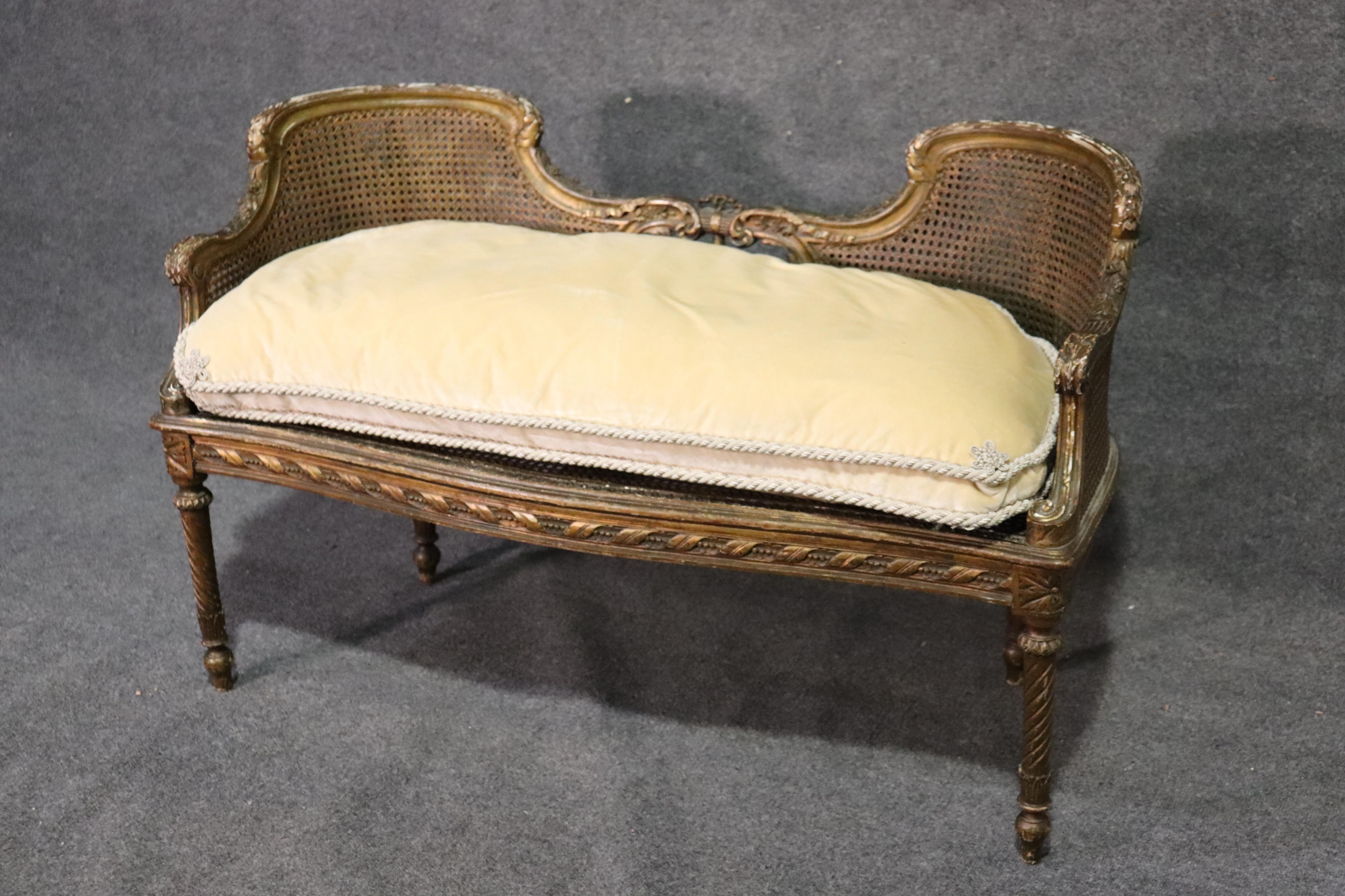 This is a gorgeous cane window bench that features a fine old genuine gold leaf surface and beautiful design and carved detail. The bench measures 45 wide x 21 deep x 29 tall and the seat height is 16 inches.