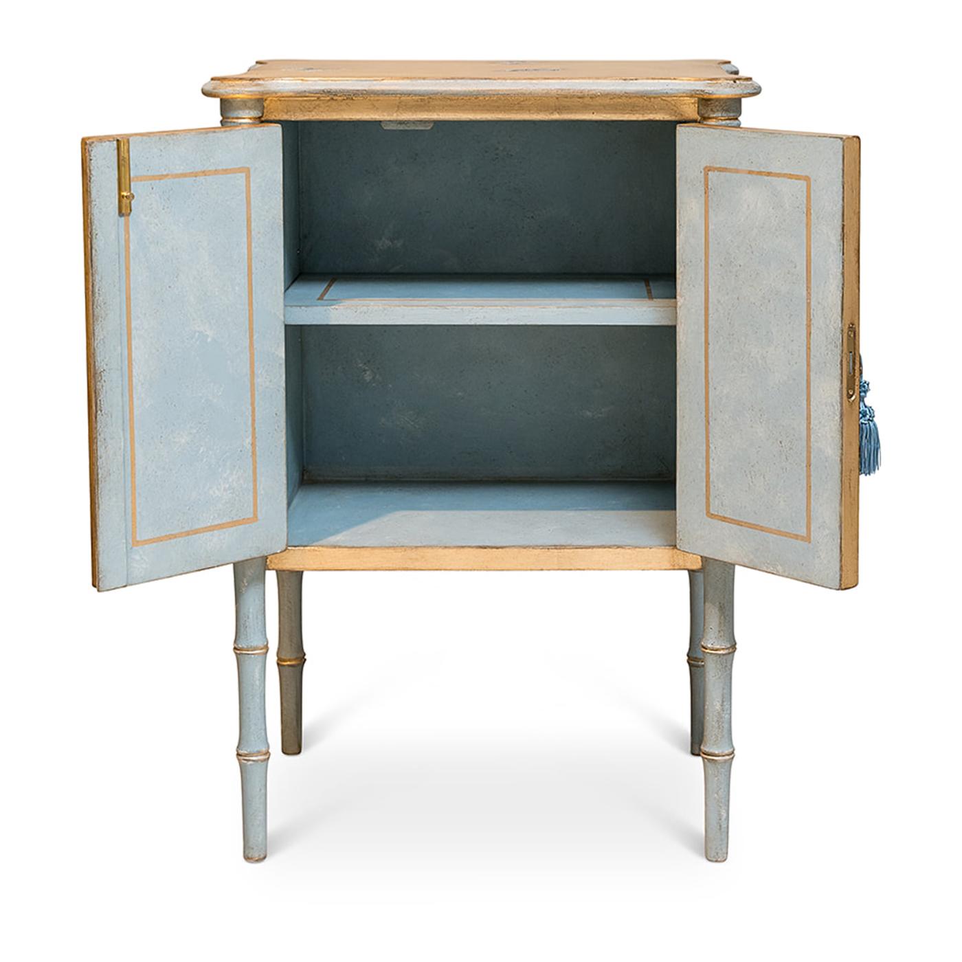 Introducing the Lombardia Bamboo nightstand, a whimsical masterpiece inspired by the kaleidoscope of colors found in a group of butterflies. Crafted with gold leaf accents and blue-grey bamboo, this nightstand adds a touch of enchantment to your