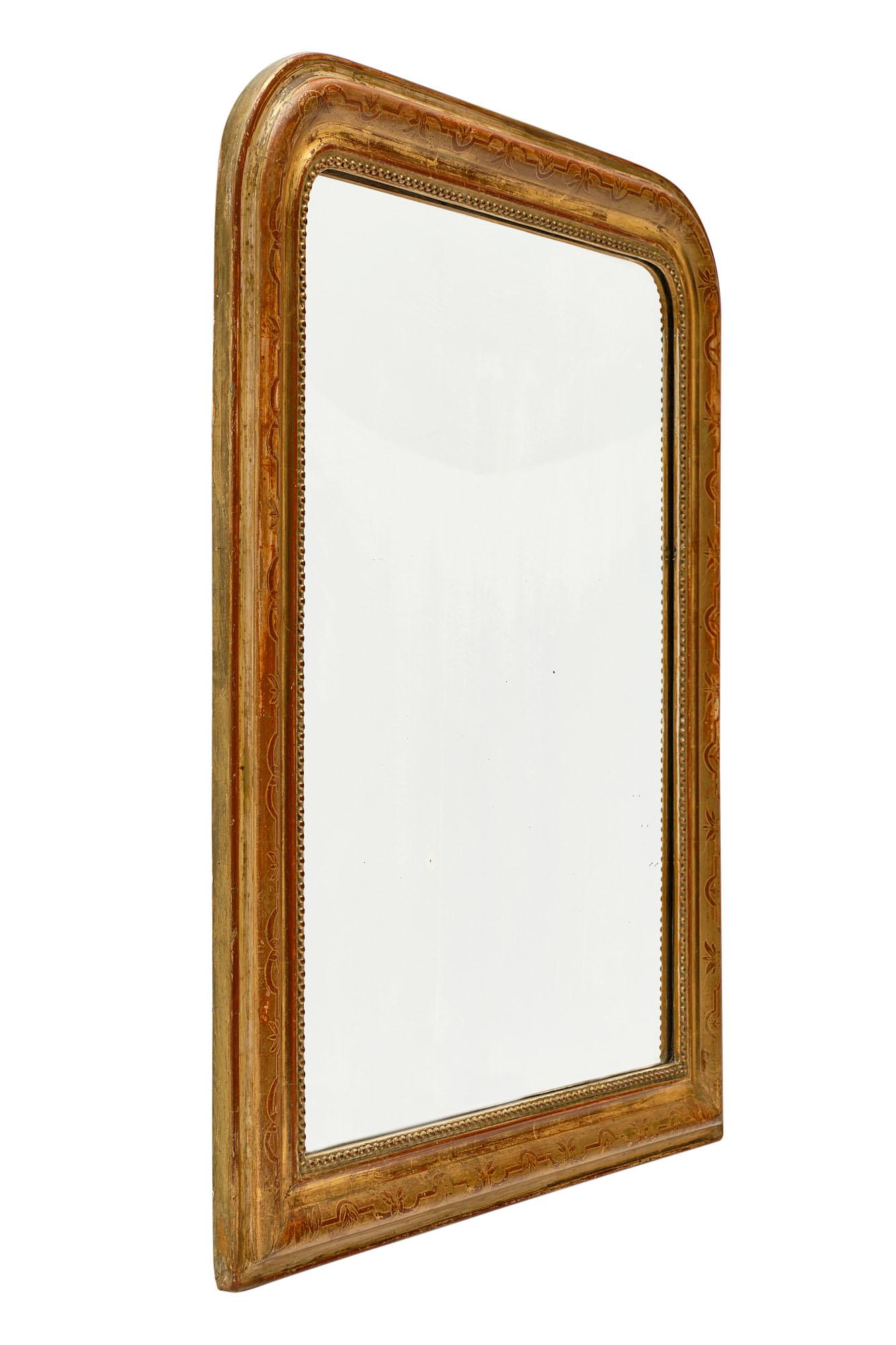 Gold leaf Louis Philippe period mirror from France with a beautiful hand-chiseled wood and gesso frame. The gold leaf has a beautiful patina and the sienna colored glaze shows through for a warm and inviting impact.