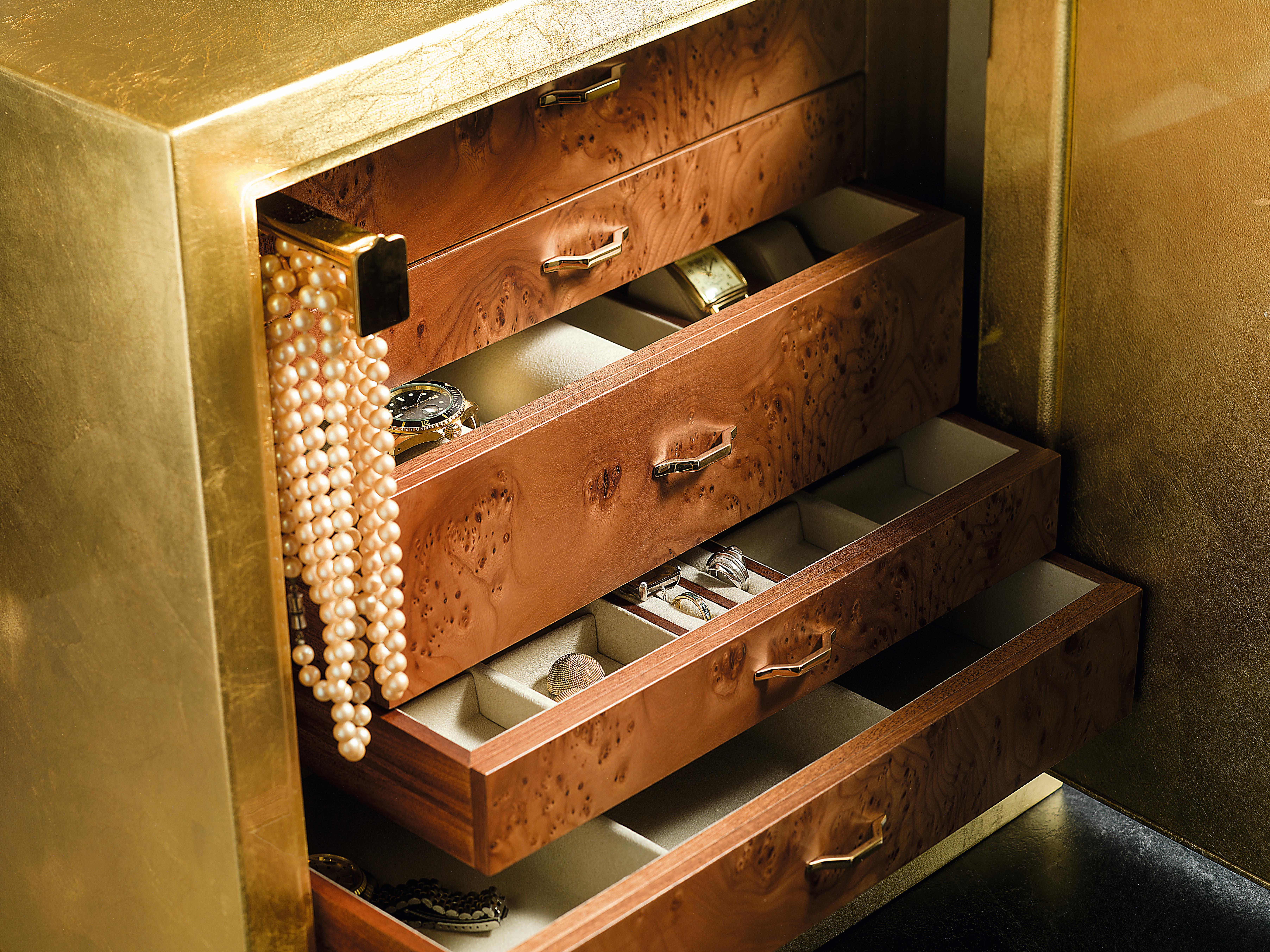 Armoured jewelry safe with pull out necklace bars. Shiny gold leaf steel. Inside drawers in polished ebony, 24 karats gold plated brass accessories.. Made in Florence, Italy by Agresti since 1949.
