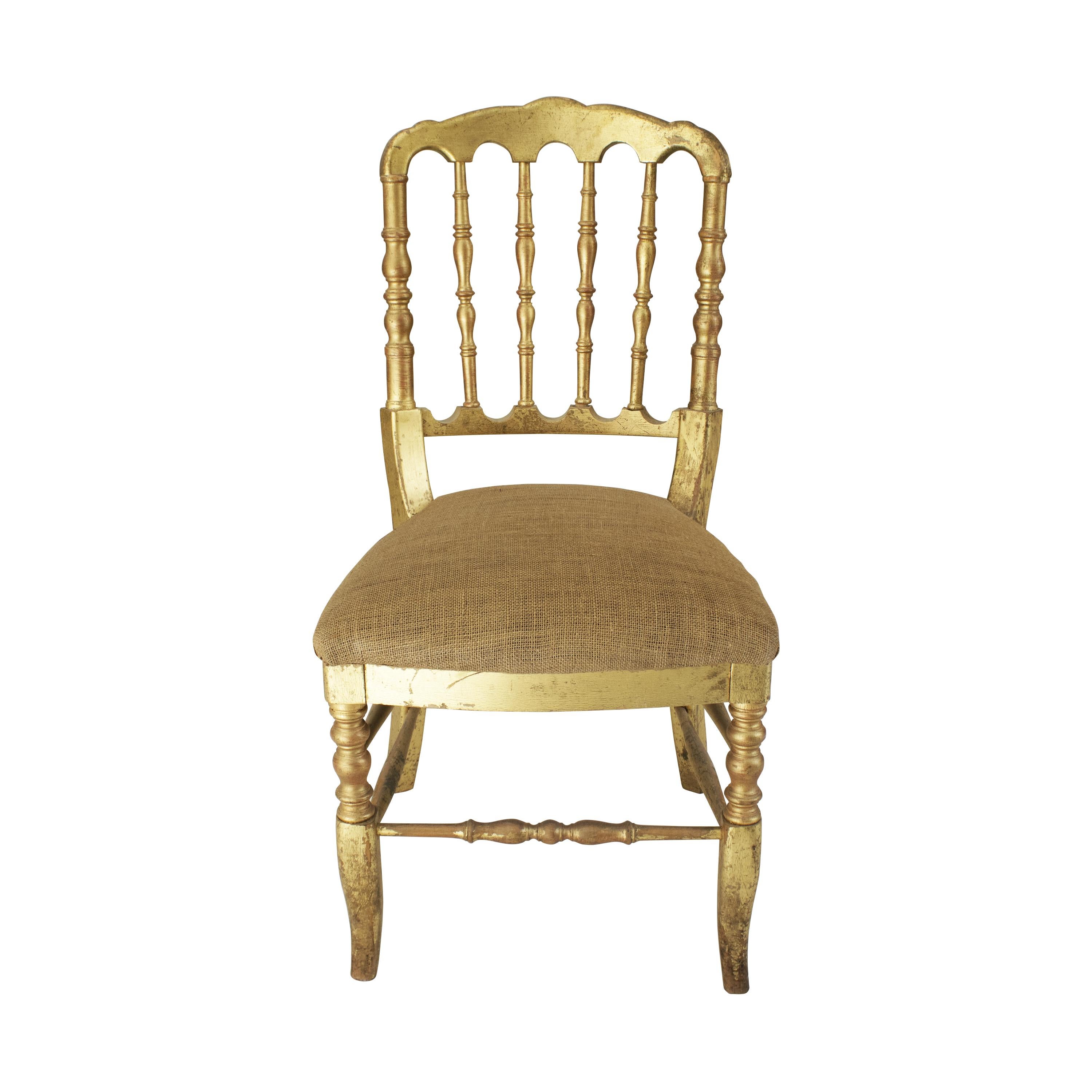 Tiffany style chair also known as the Chiavari chair made in France circa 1960s. The structure of the chair is made entirely of solid wood turned by hand and polychromed with handmade gold leaf. The padded seat is upholstered in raffia.

Price by