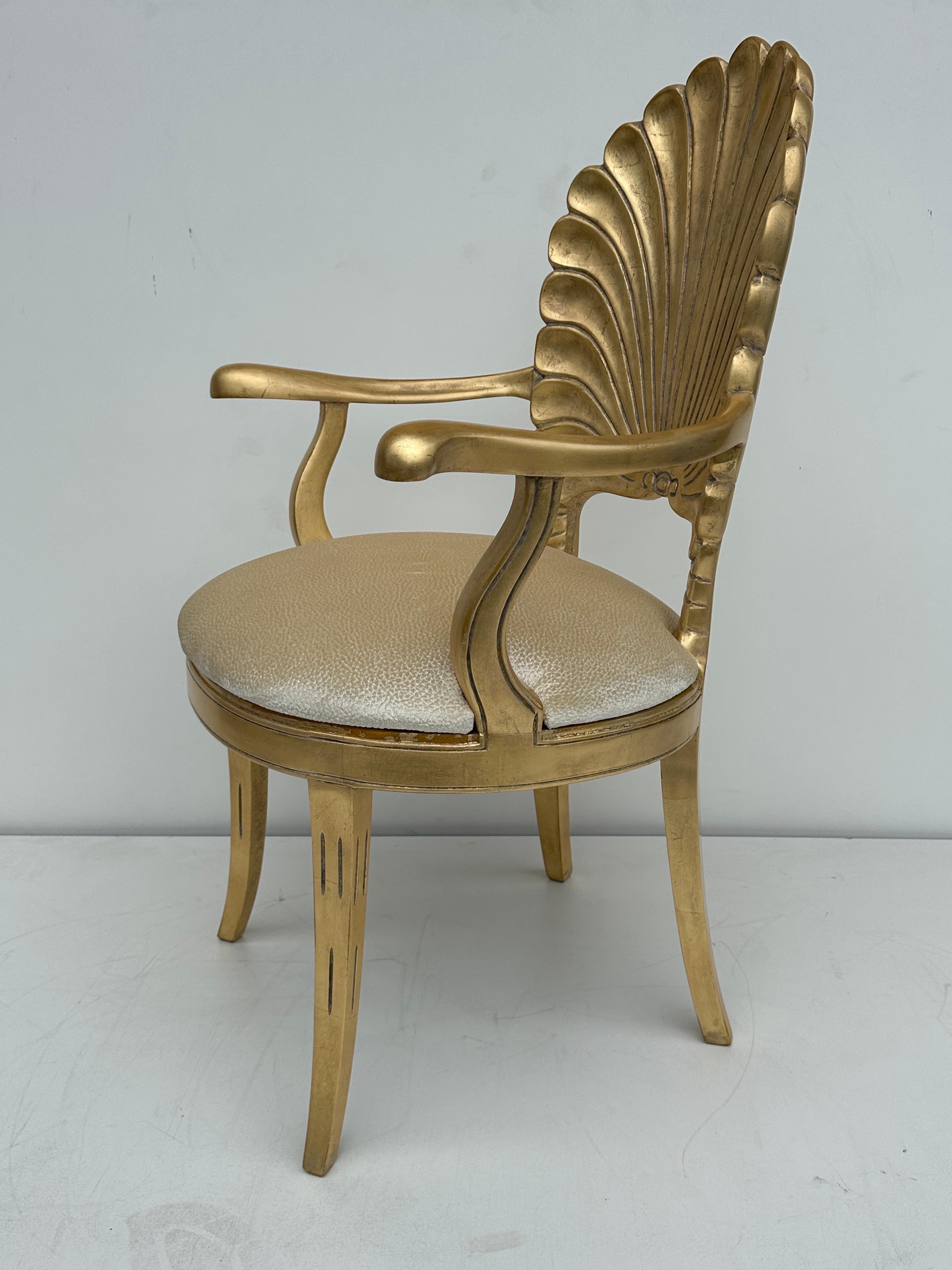 Antique gold leaf Venetian grotto style shell back armchair. Seat has been newly reupholstered in champagne color velvety fabric.
Arm height is 26.5
