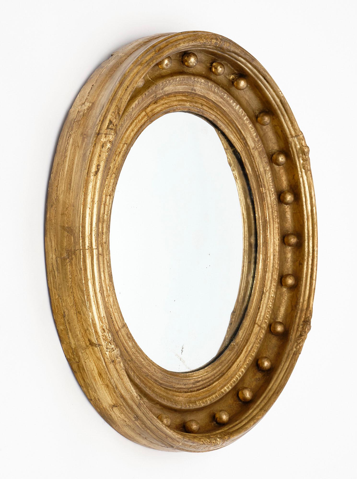Gold leafed French antique mirror with a hand carved frame that has been gold leafed and the original central convex mirror.
