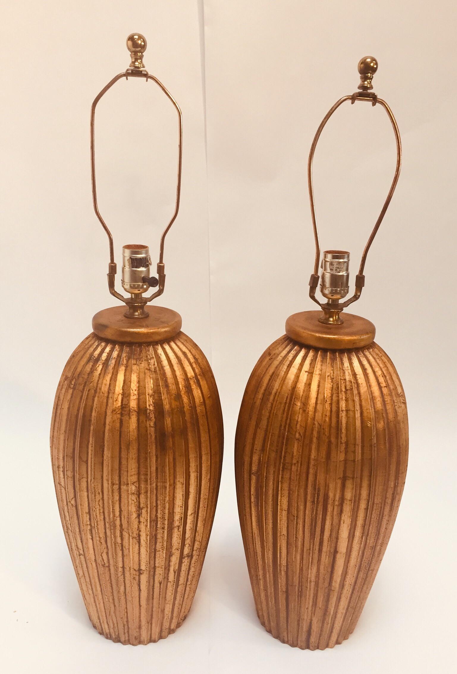 Fabulous pair of gold leafed wooden table lamps in melon shape.
American, circa 1970s.
Beautiful vintage modern shape.
Just add your shades.
Total height with harp: 30