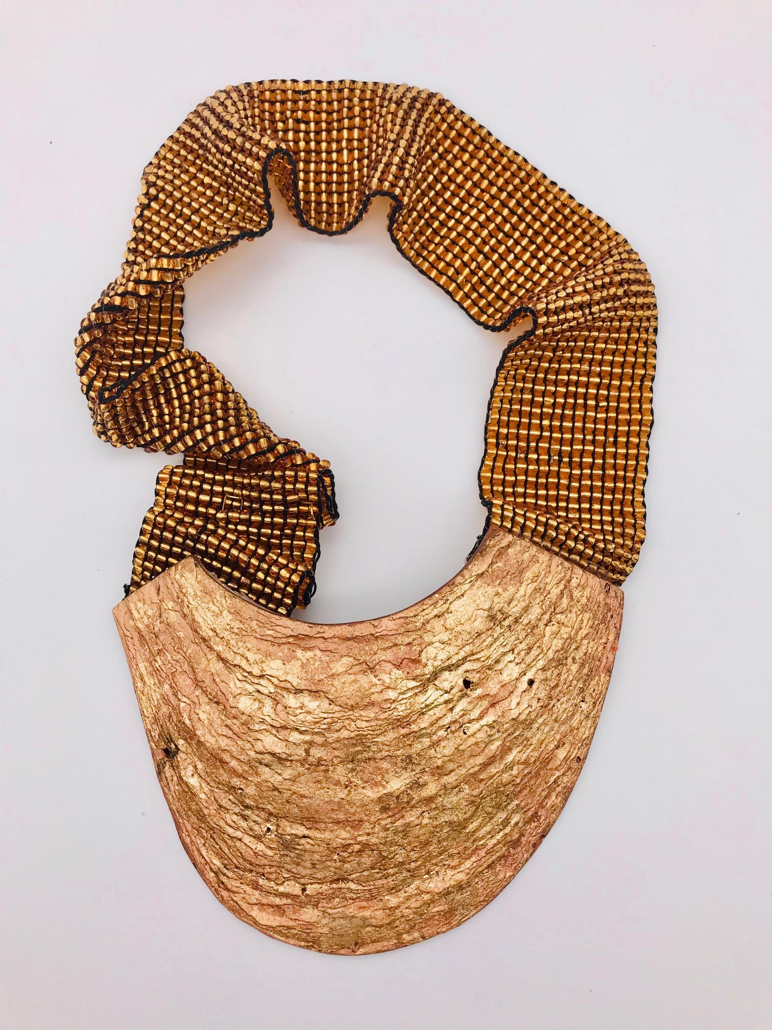 
This Statement Necklace was featured in the press and worn on the Fashion Show in Sri Lanka in 2018 The front of the shell is gold leafed and the pendant is attached to a gold glass bead stretchy strap.The	Pinna Nobilis  is  an iconic shell in the