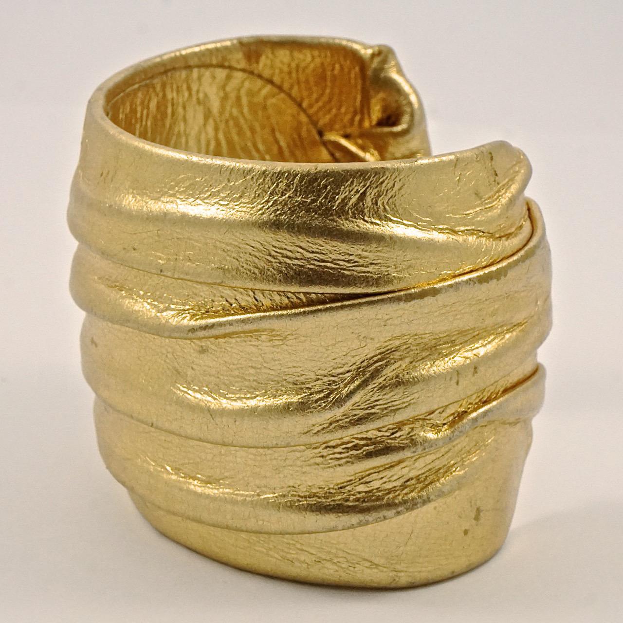 Wonderful gold leather covered bangle cuff bracelet. The gold leather has a lovely overlapping design. Measuring inside diameter width 5.9cm / 2.3 inches by width 5.1cm / 2 inches. The bracelet is in very good condition, with minor gold loss to the