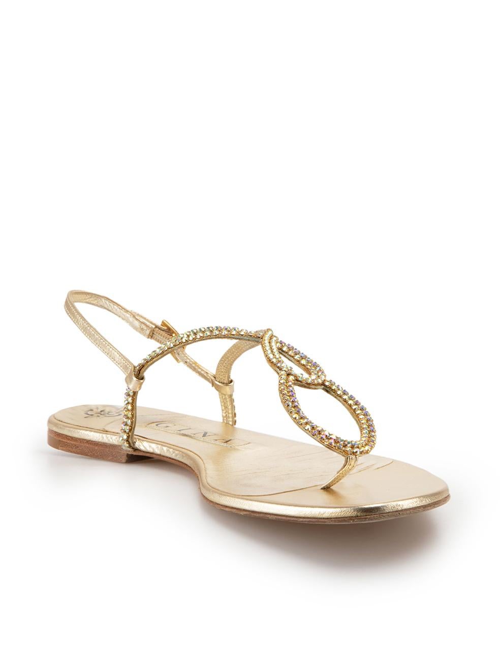 CONDITION is Good. Minor wear to sandals is evident. Light creasing to inner sole on this used Gina designer resale item. Dustbag included.



Details


Gold 

Leather

Flat thong sandals

Crystal embellished

Adjustable ankle