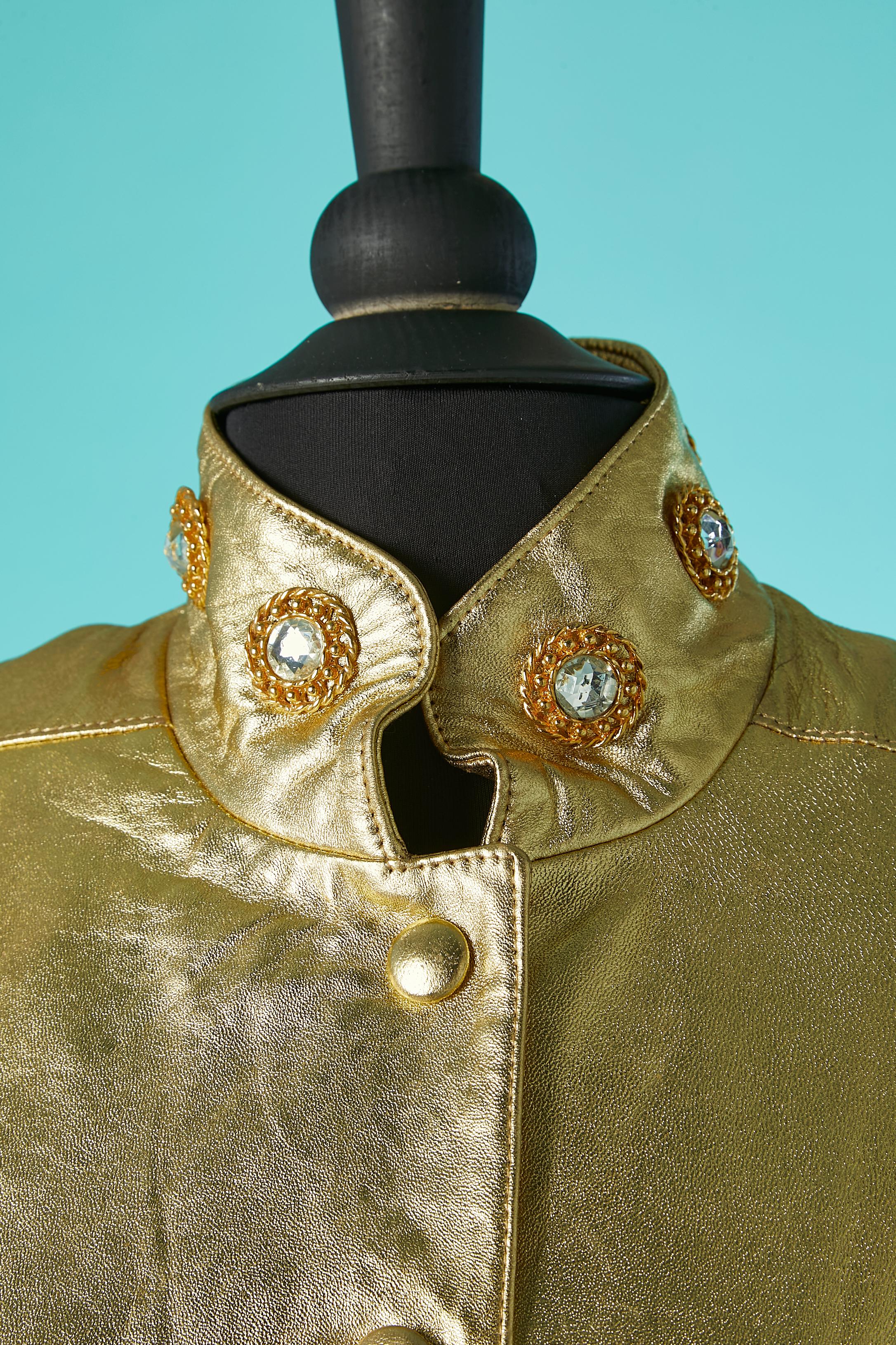 Gold leather jacket with glass cabochons and metal. Snap middle front covered with leather. Cut-work. 
No fabric composition tag but lining probably rayon. 
SIZE M 