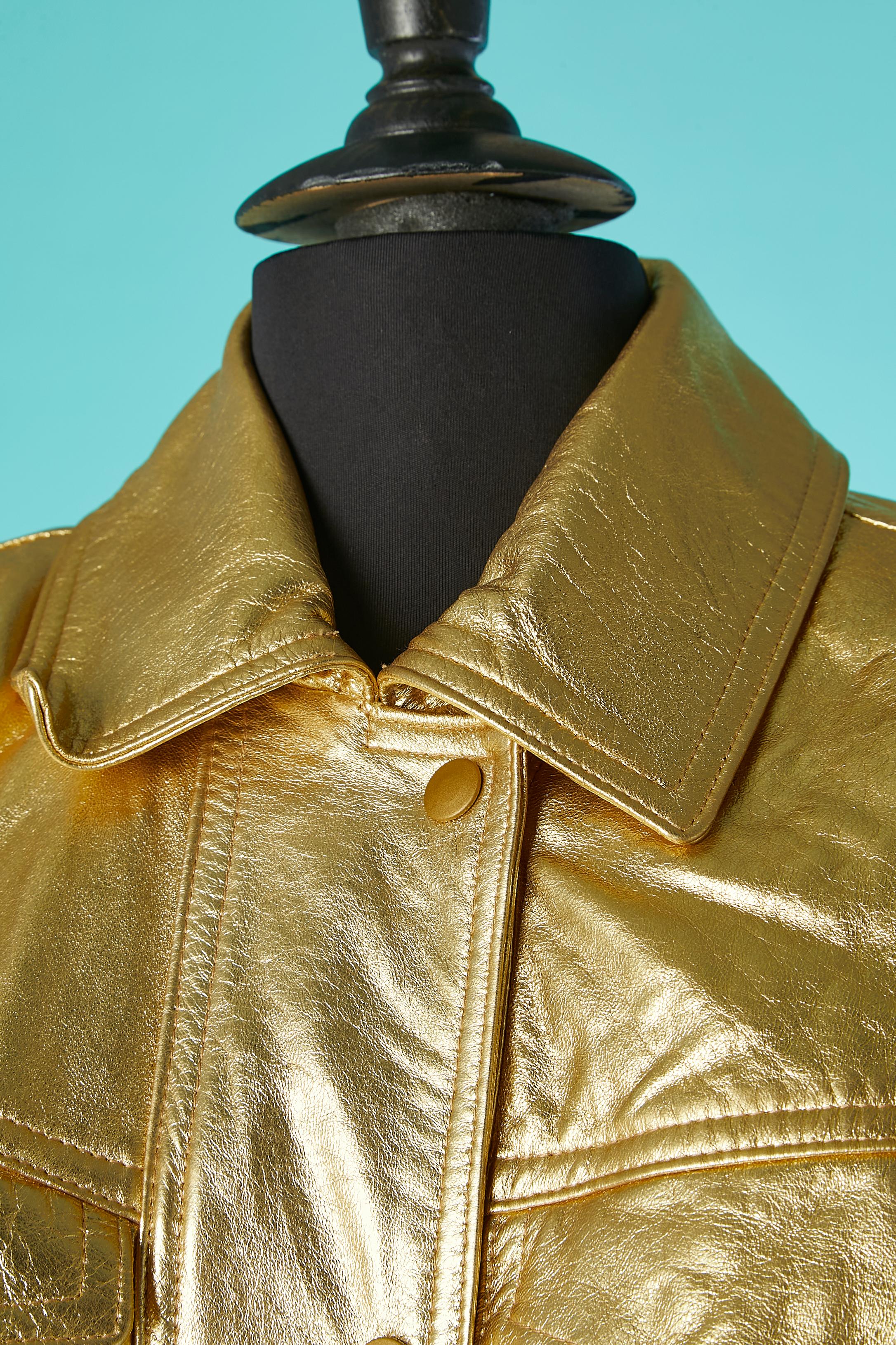 Gold leather skirt-suit. Snap closure in the middle front. Larges shoulder-pads. 
No fabric tag but probably acetate lining. 
SIZE 10 (US) 